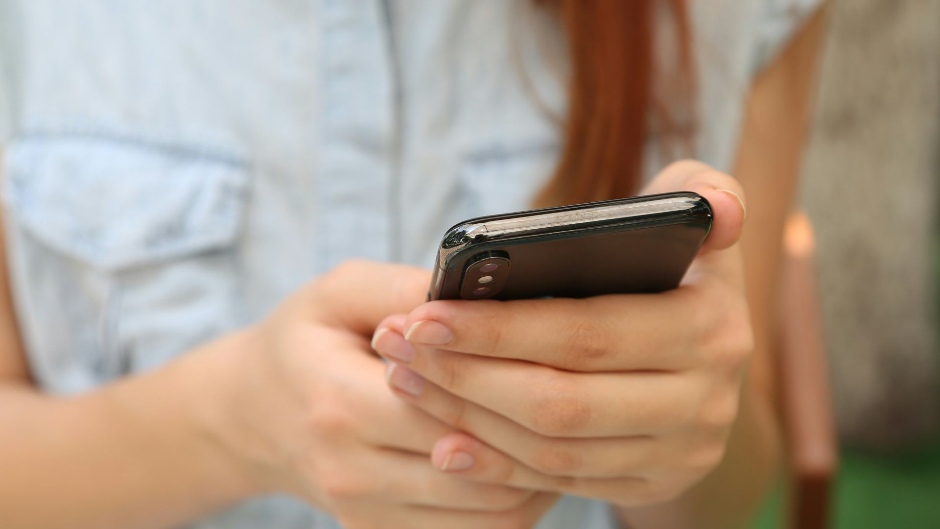 person holding using iPhone X