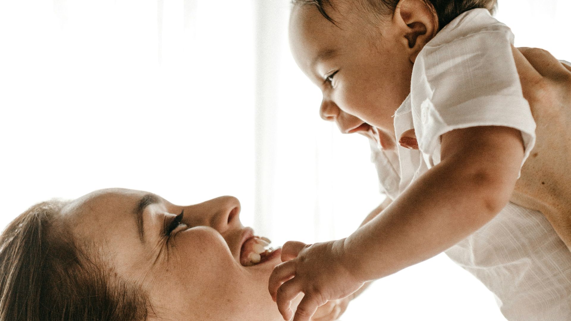 woman holding baby up
