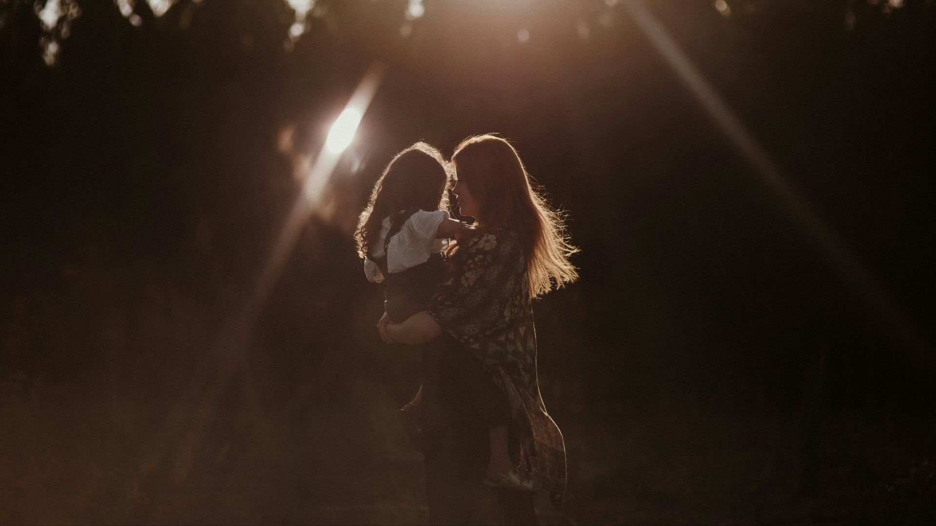 a woman holding a baby in her arms