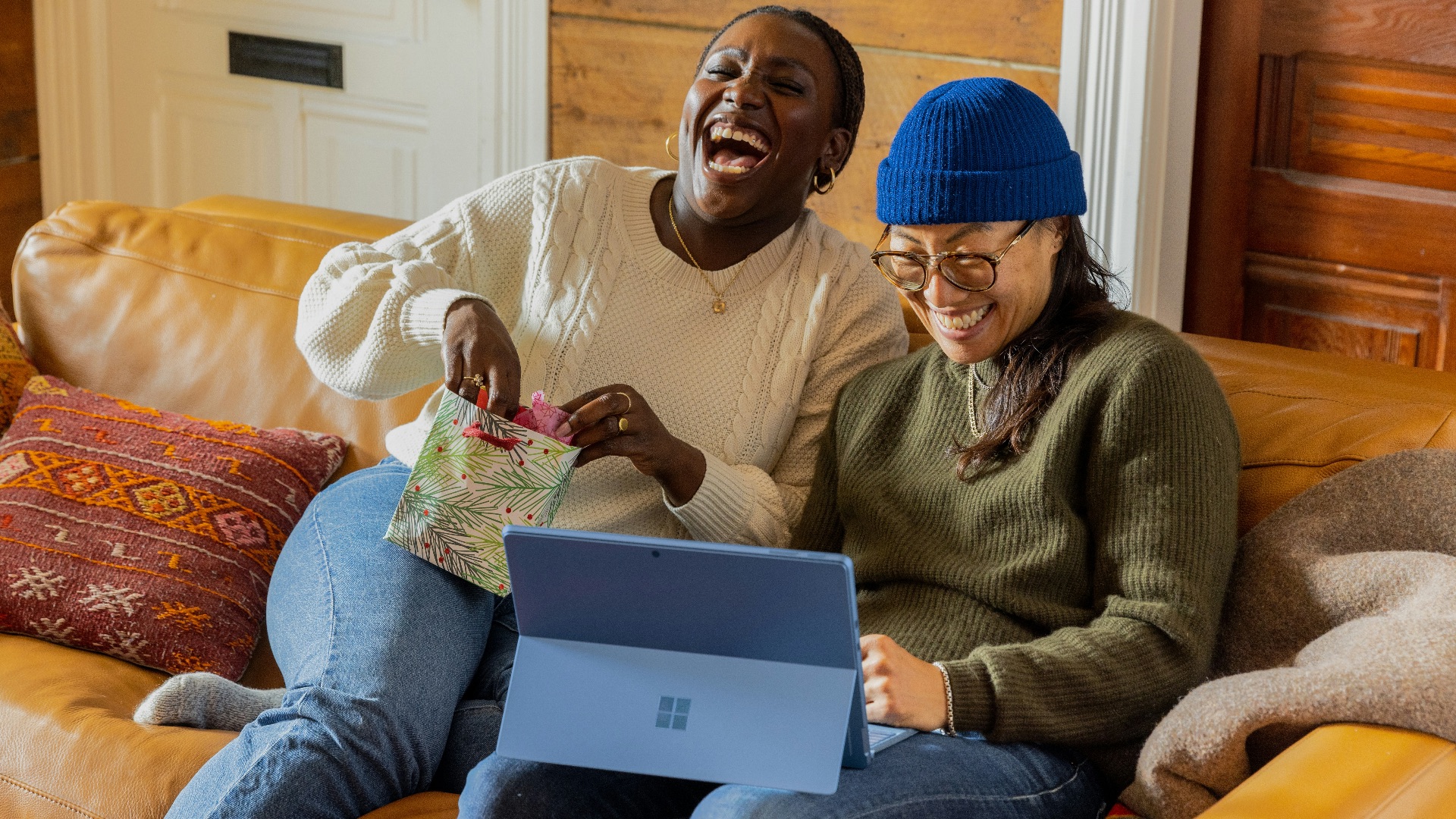 a person sitting on a couch with a laptop