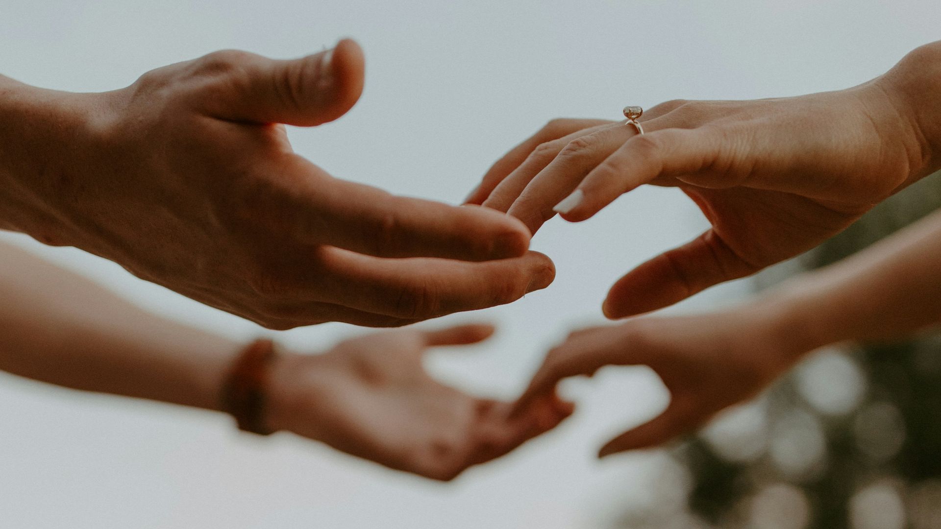 a group of people reaching out their hands