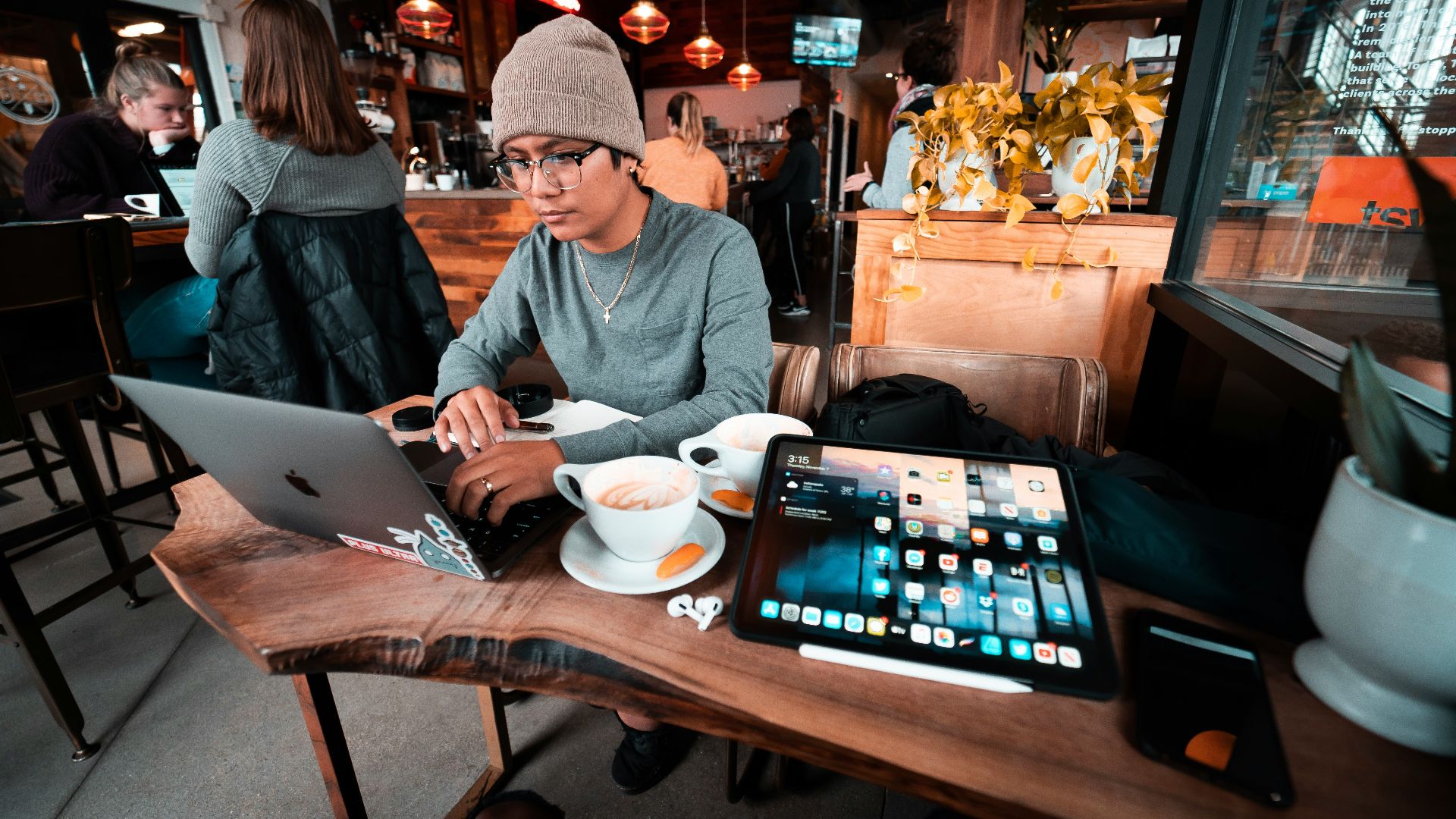 a man sitting at a table working on a laptop