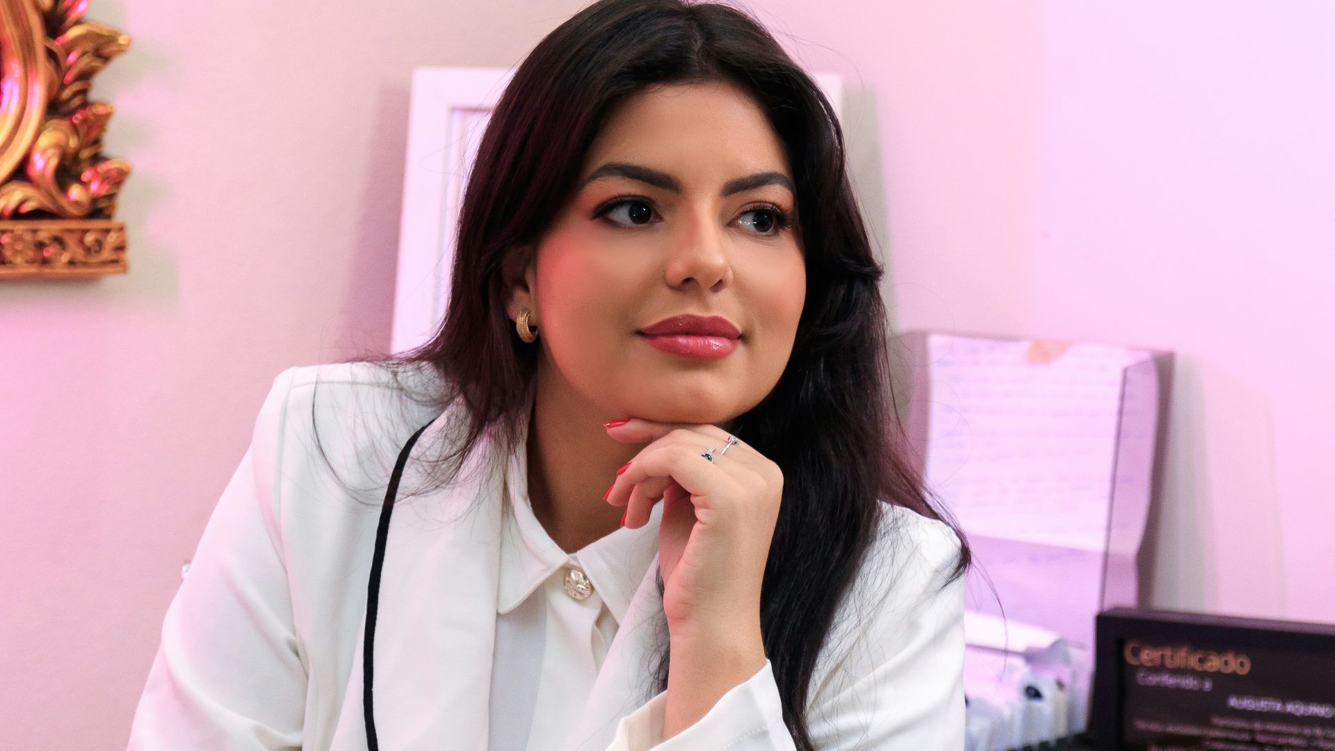 a woman sitting at a desk in front of a mirror