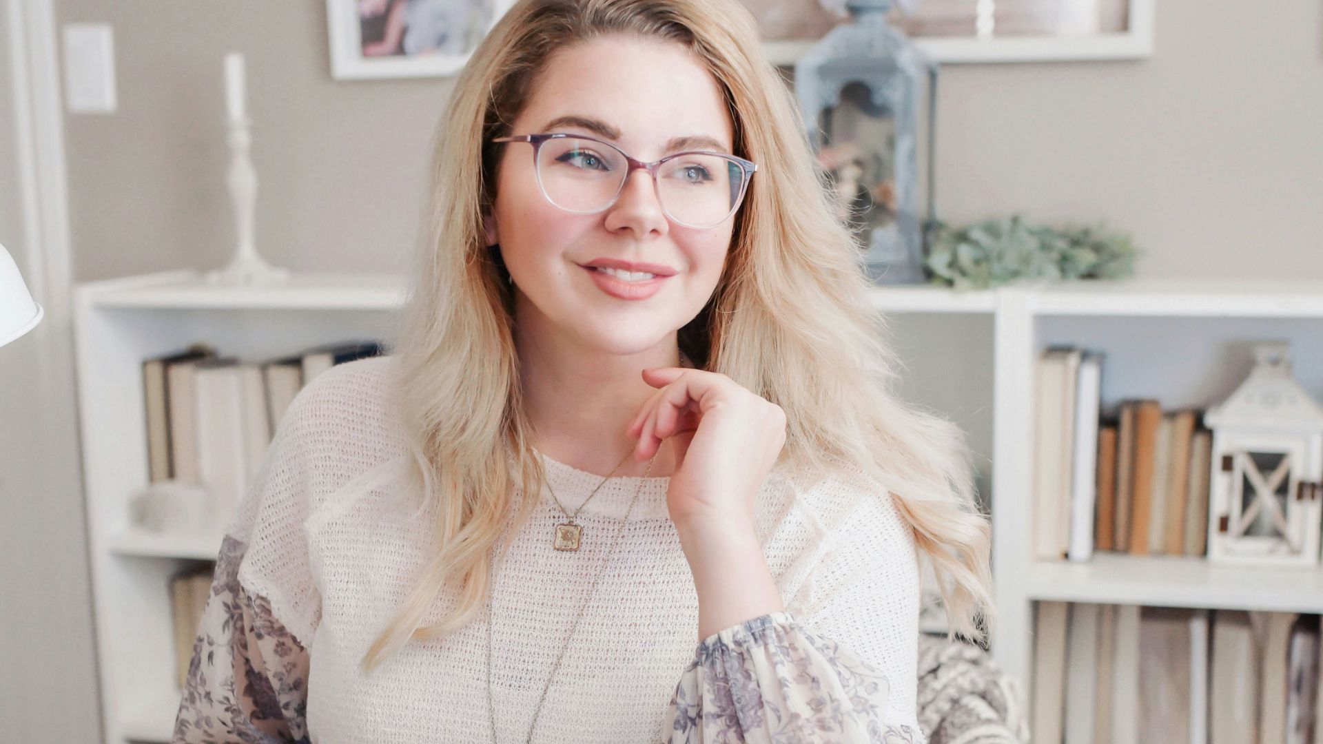 woman in white lace long sleeve shirt using silver macbook
