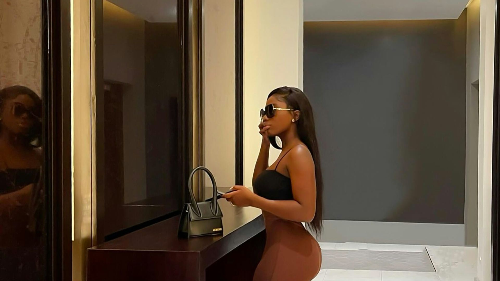 A woman standing in a hallway next to a counter