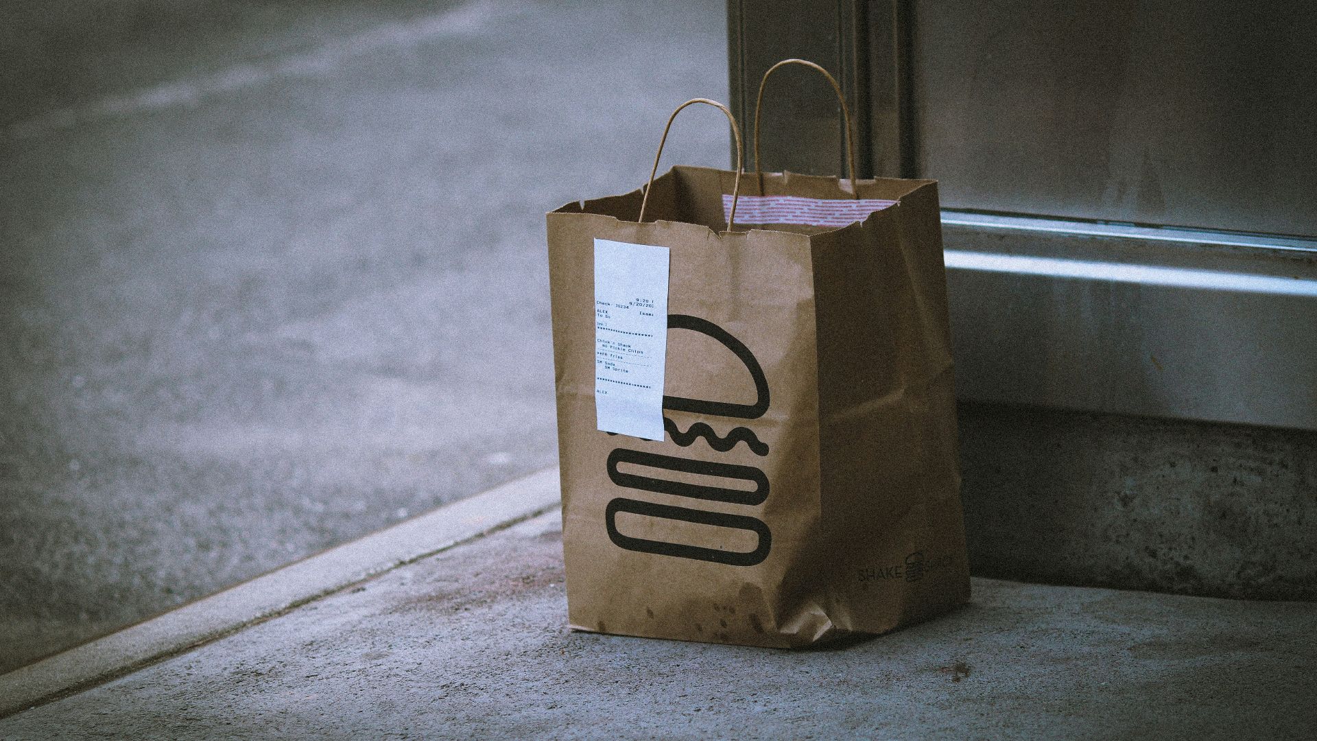 brown paper bag on gray concrete floor