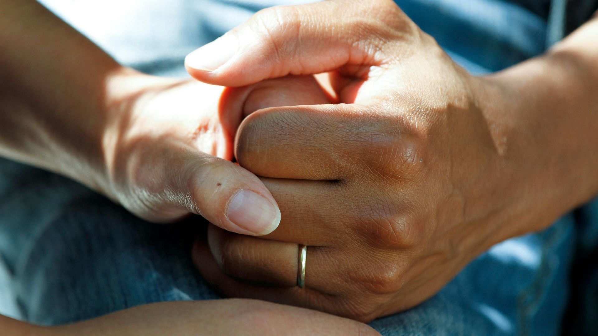 person wearing gold wedding band