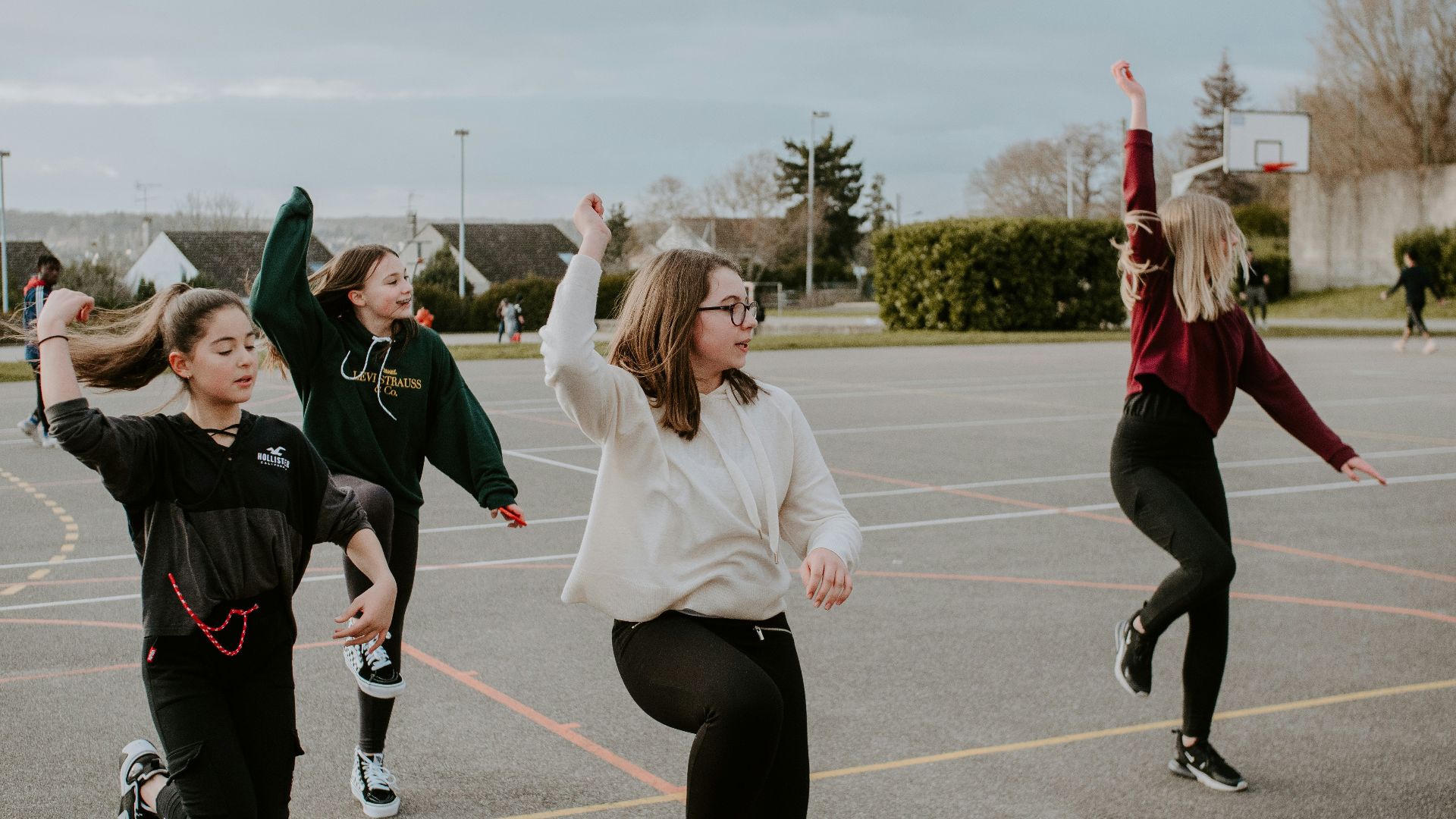 woman in white long sleeve shirt and black pants doing yoga during daytime