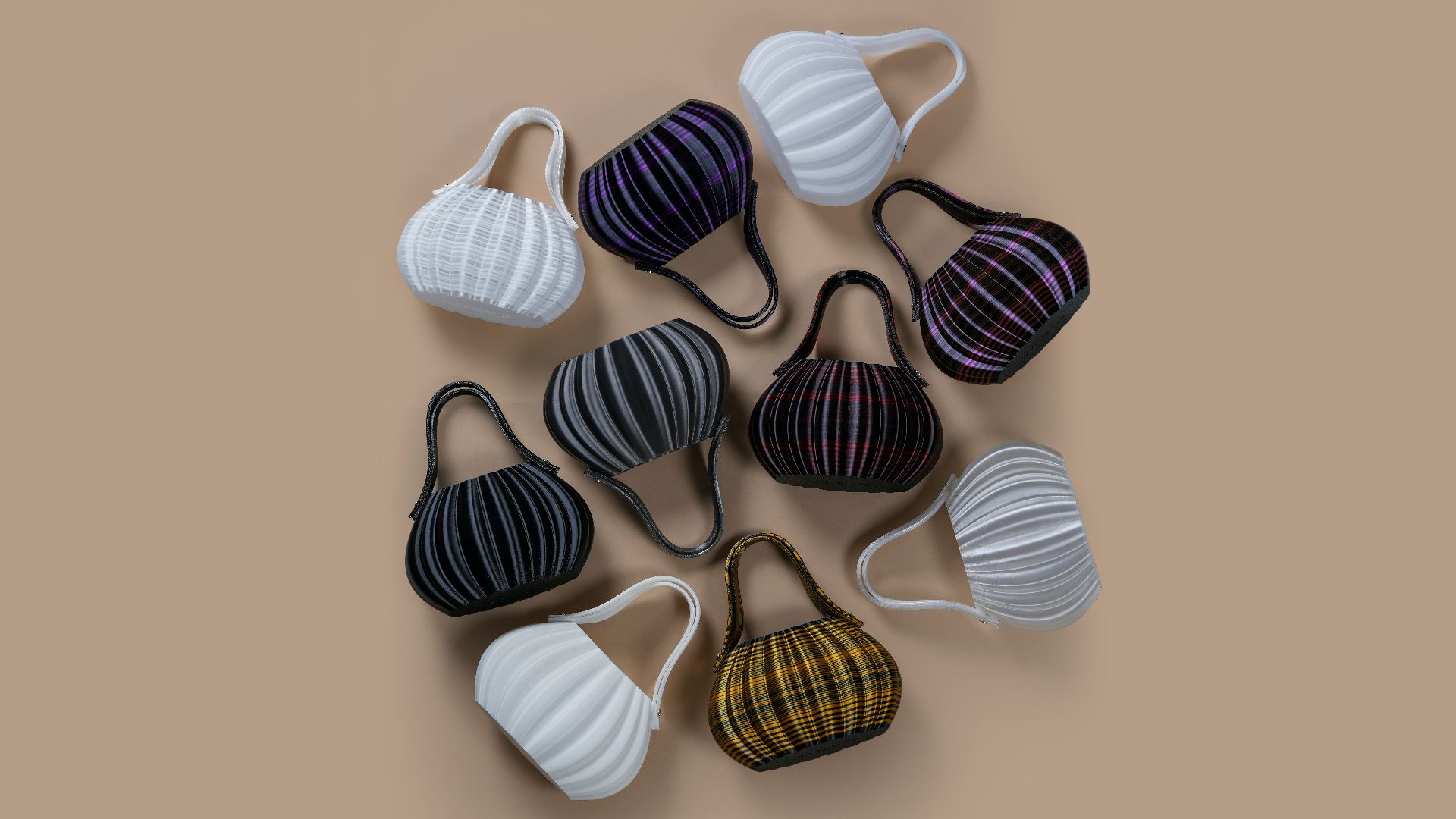 Collection of small, colorful, pleated handbags arranged on a surface.