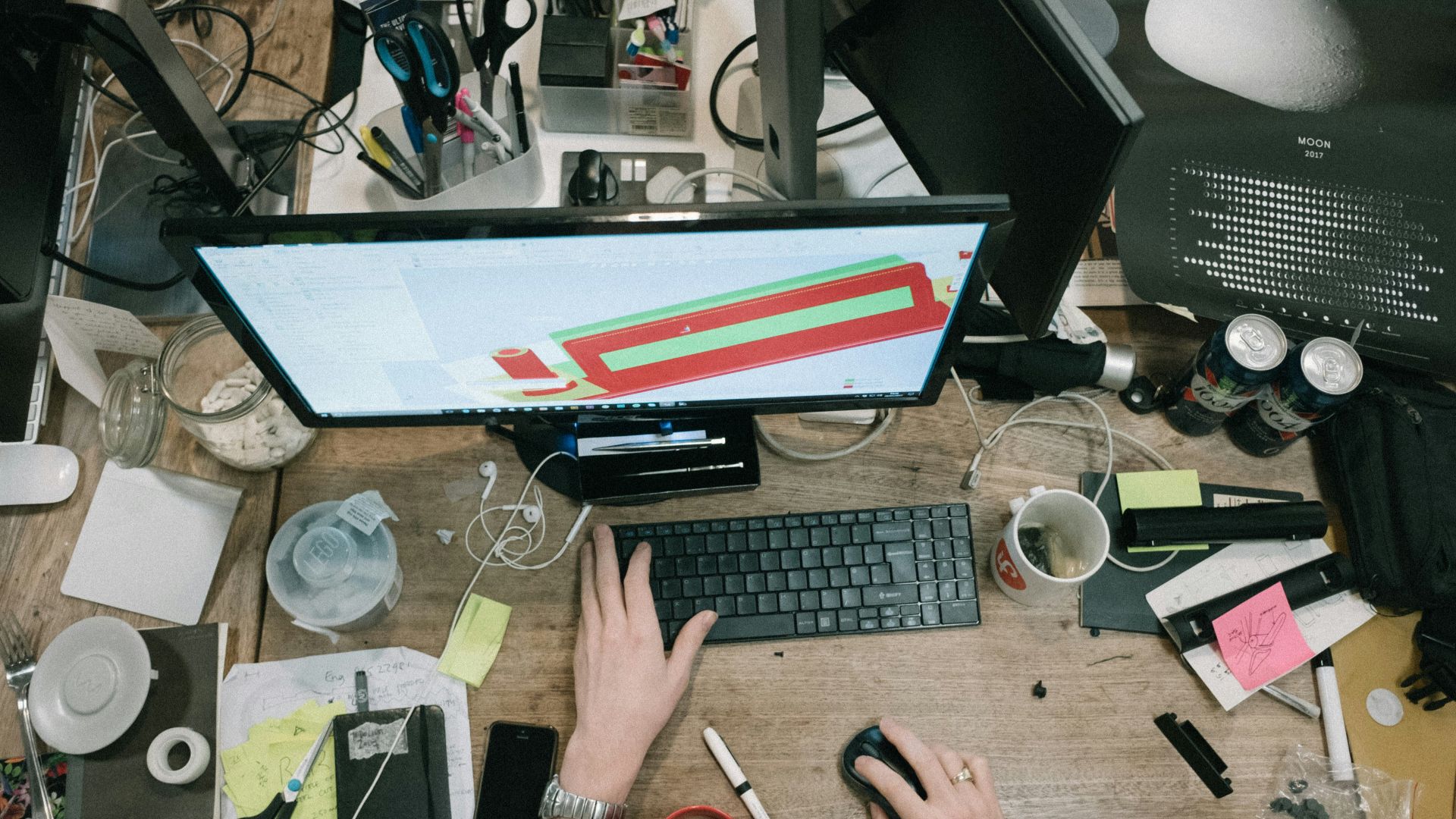 person using computer on brown wooden table
