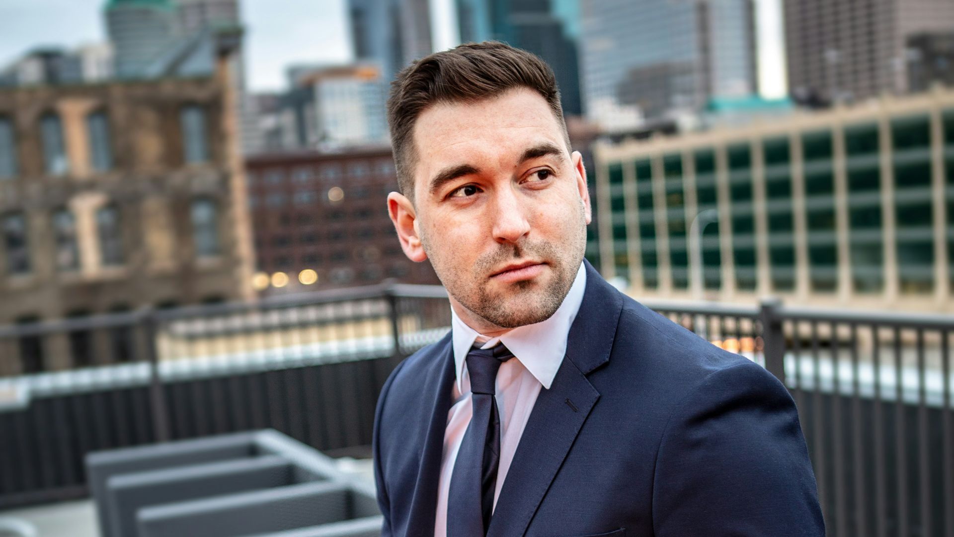 man in suit jacket sitting down