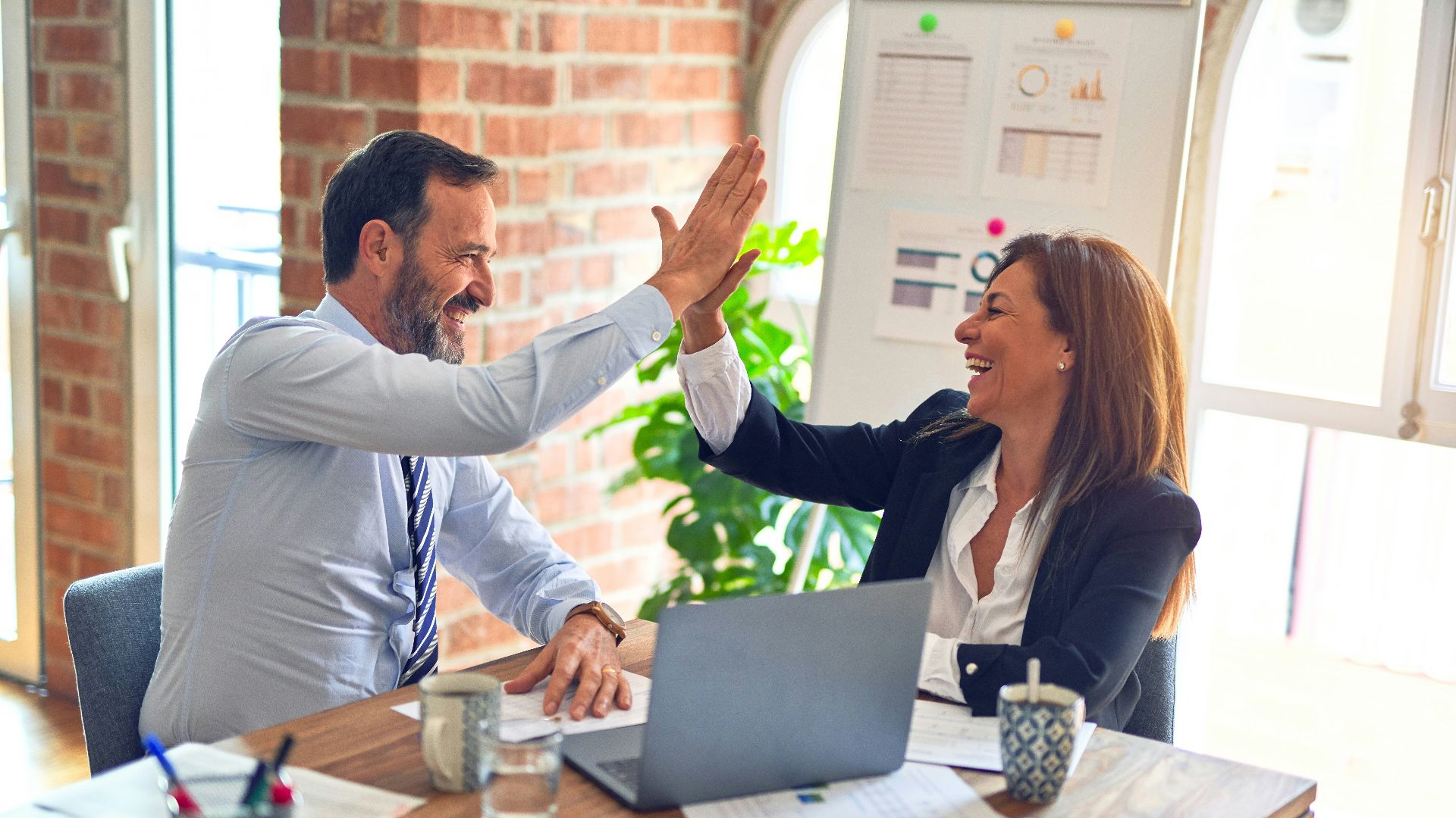 man in white dress shirt sitting beside woman in black long sleeve shirt