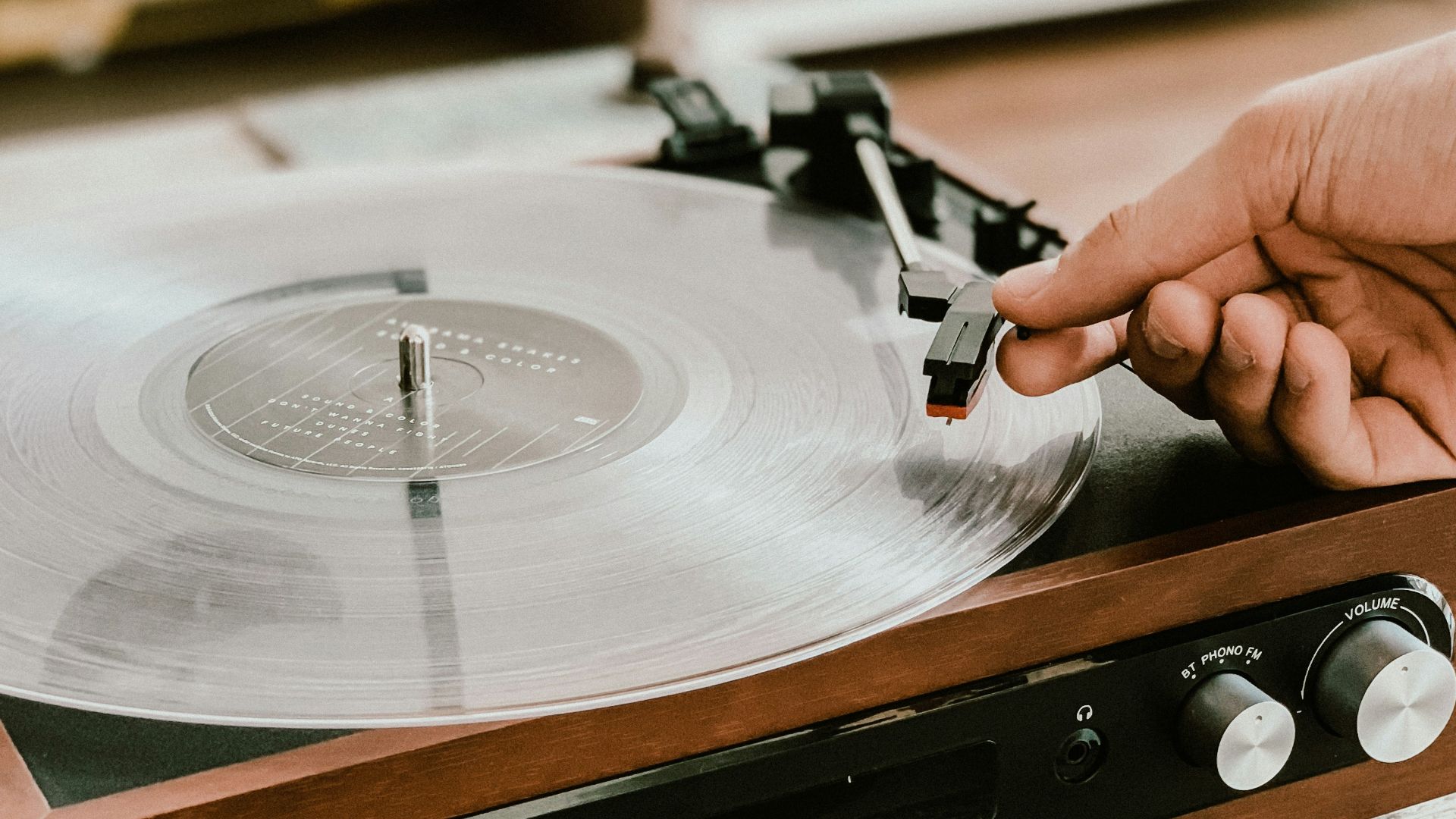 person playing record on Victrola turntable