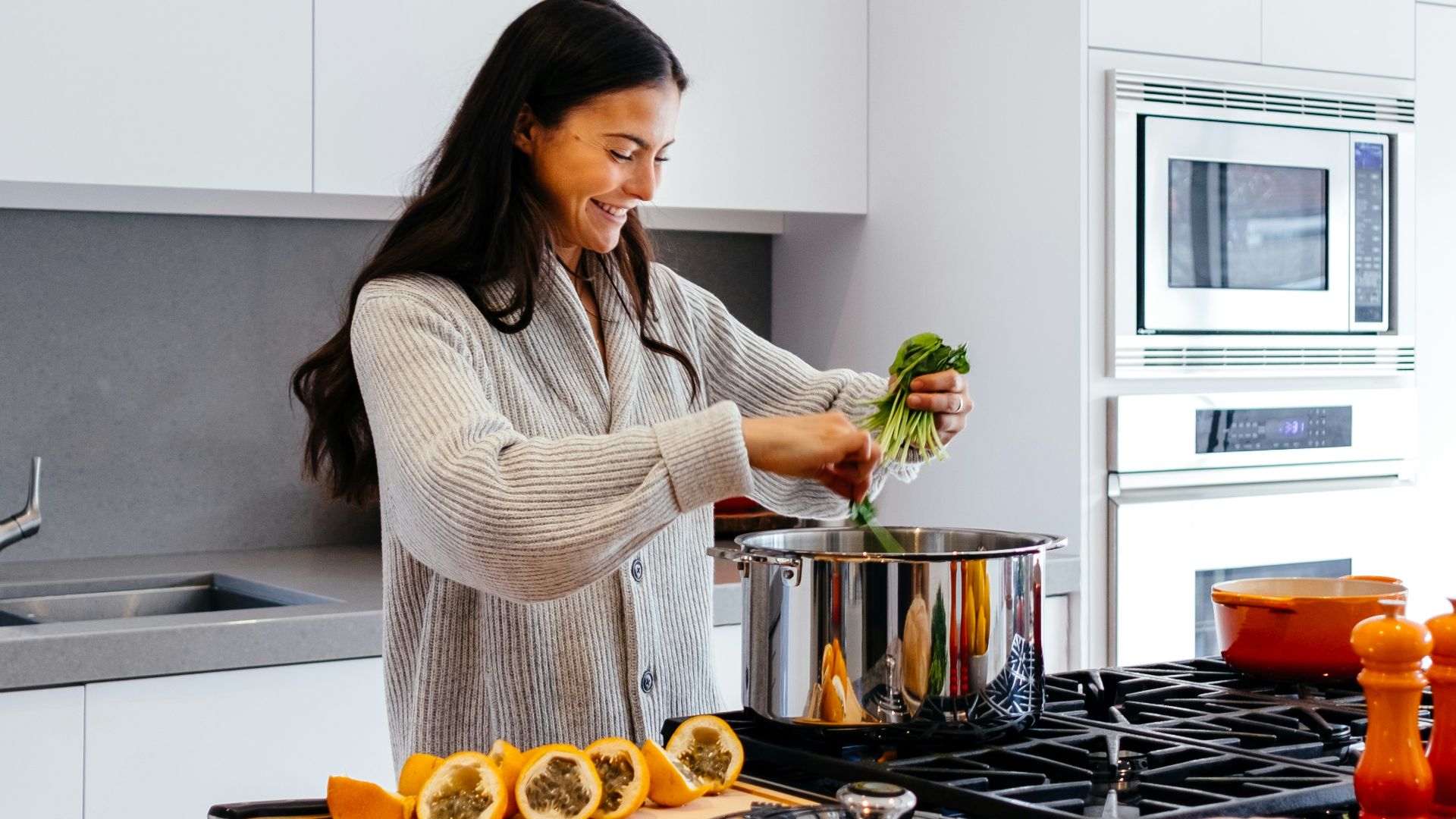 woman smiling while cooking
