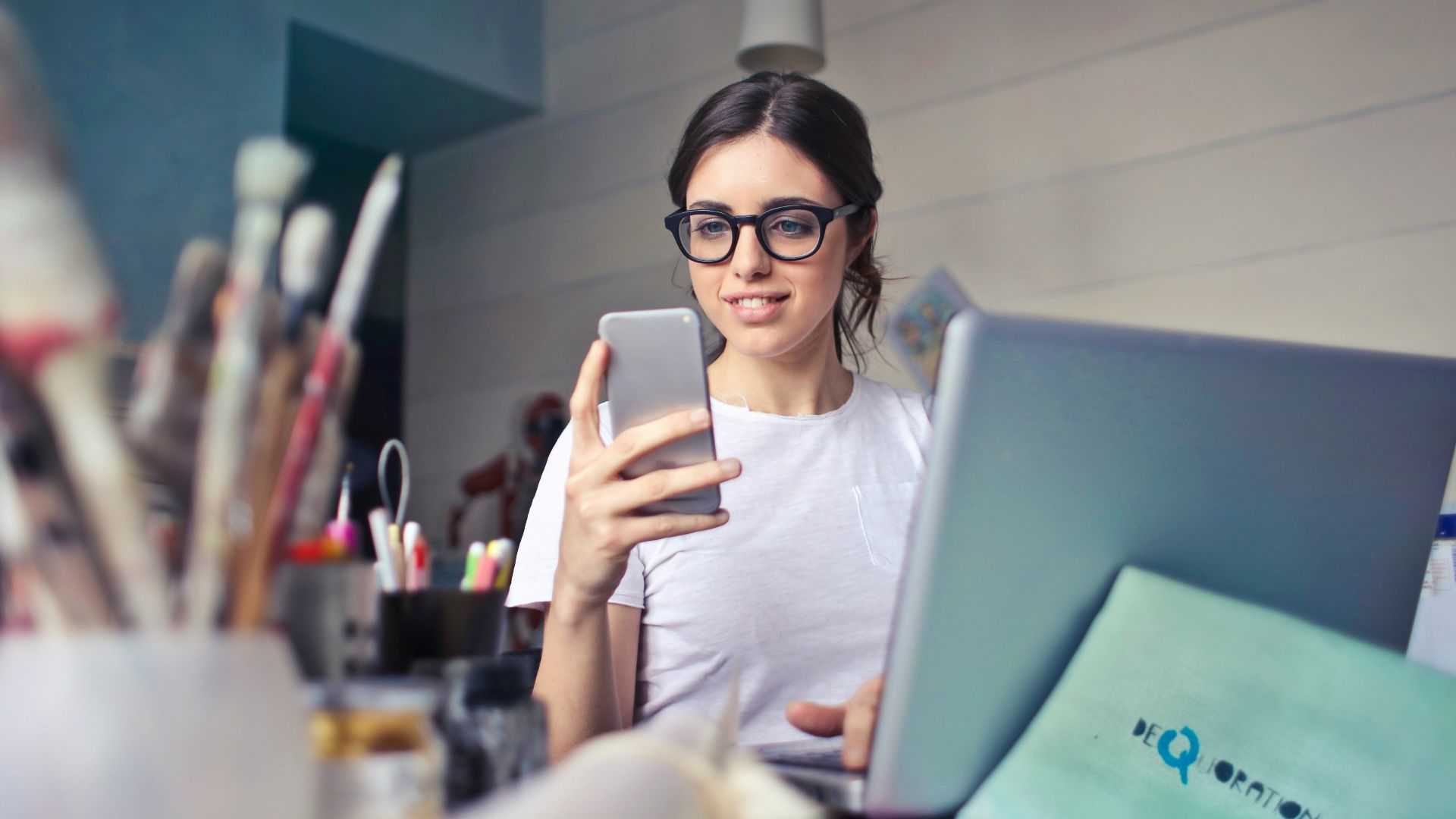 woman in white shirt using smartphone