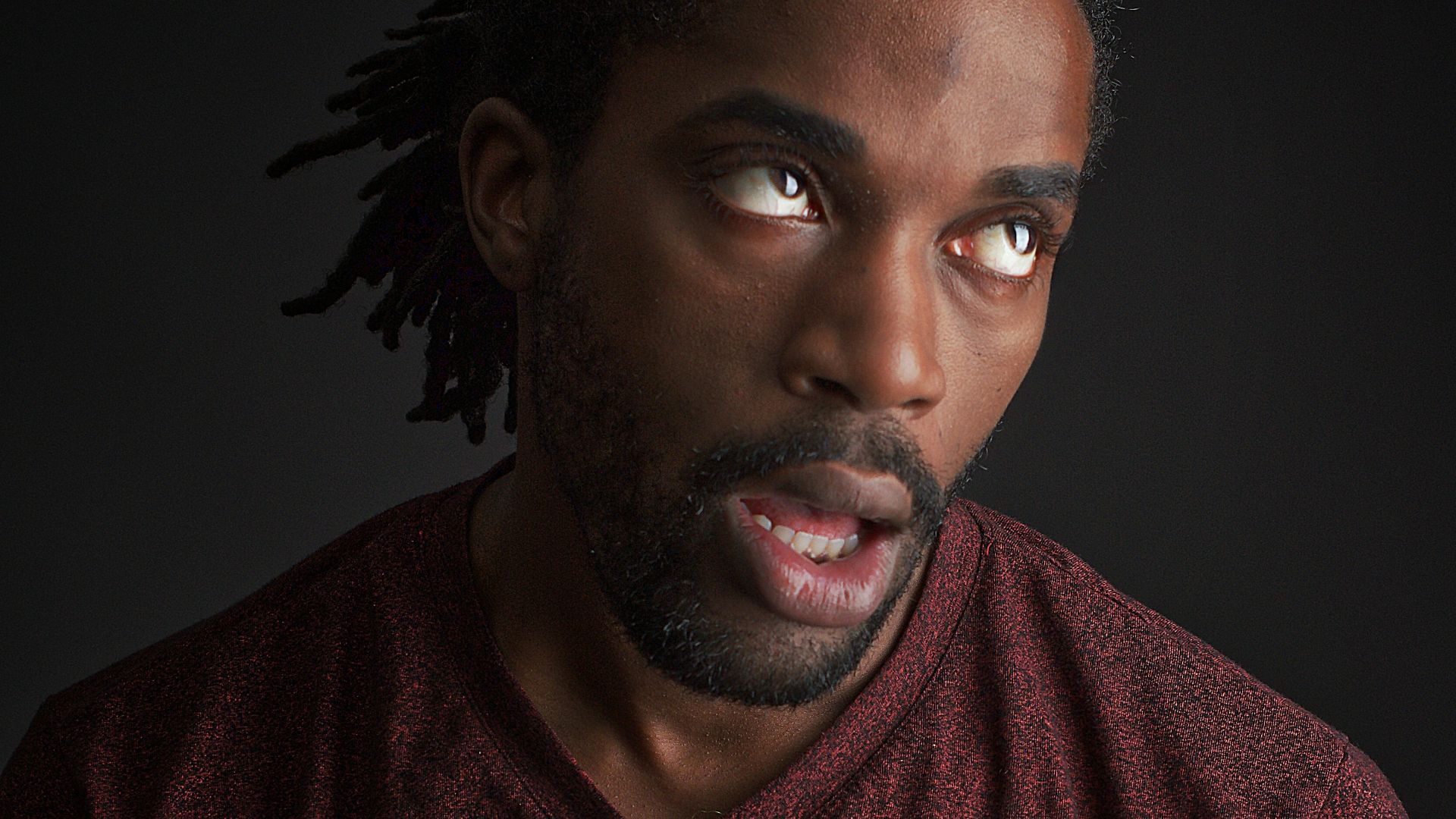 man opening his mouth and looking up