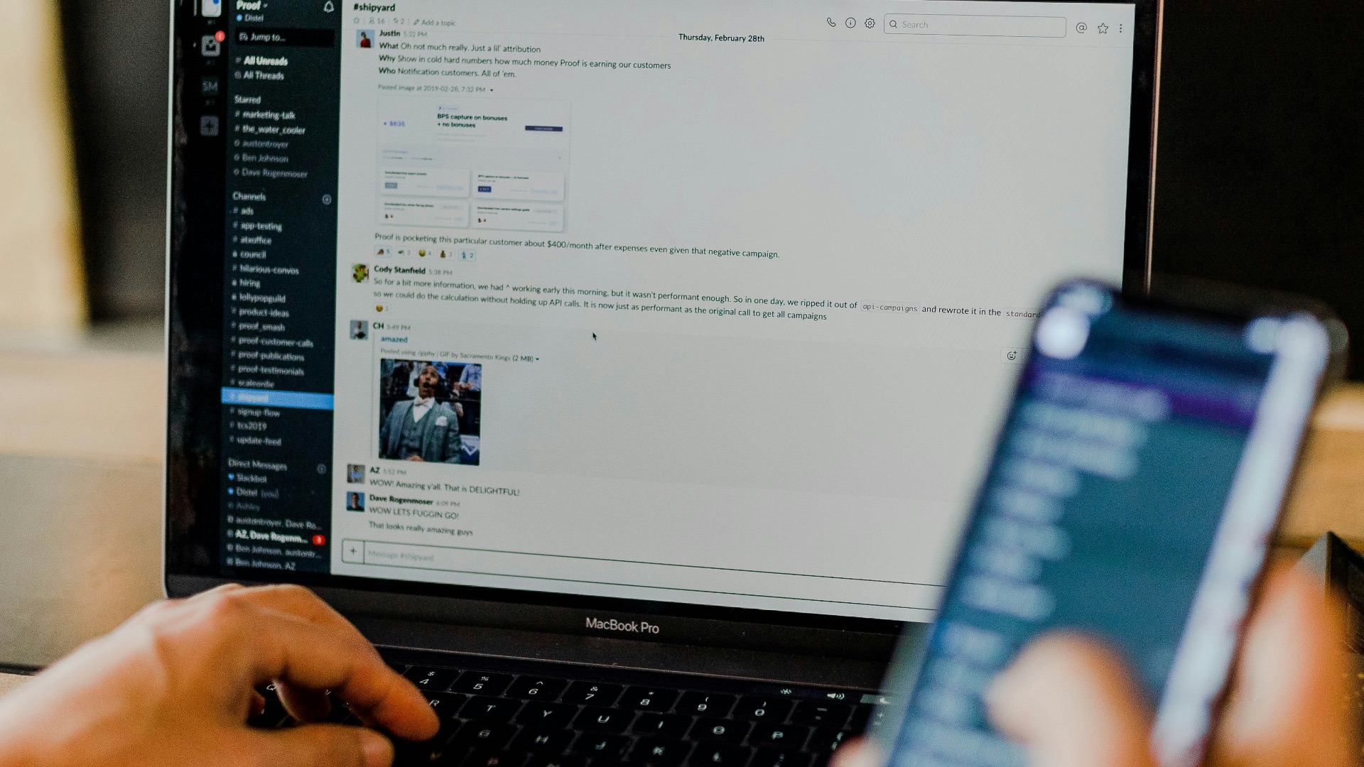 person using phone and laptop