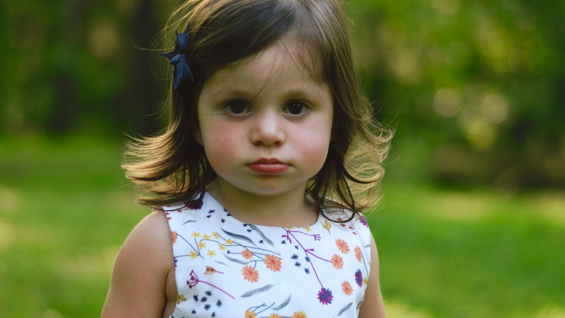 toddler girl standing on grass