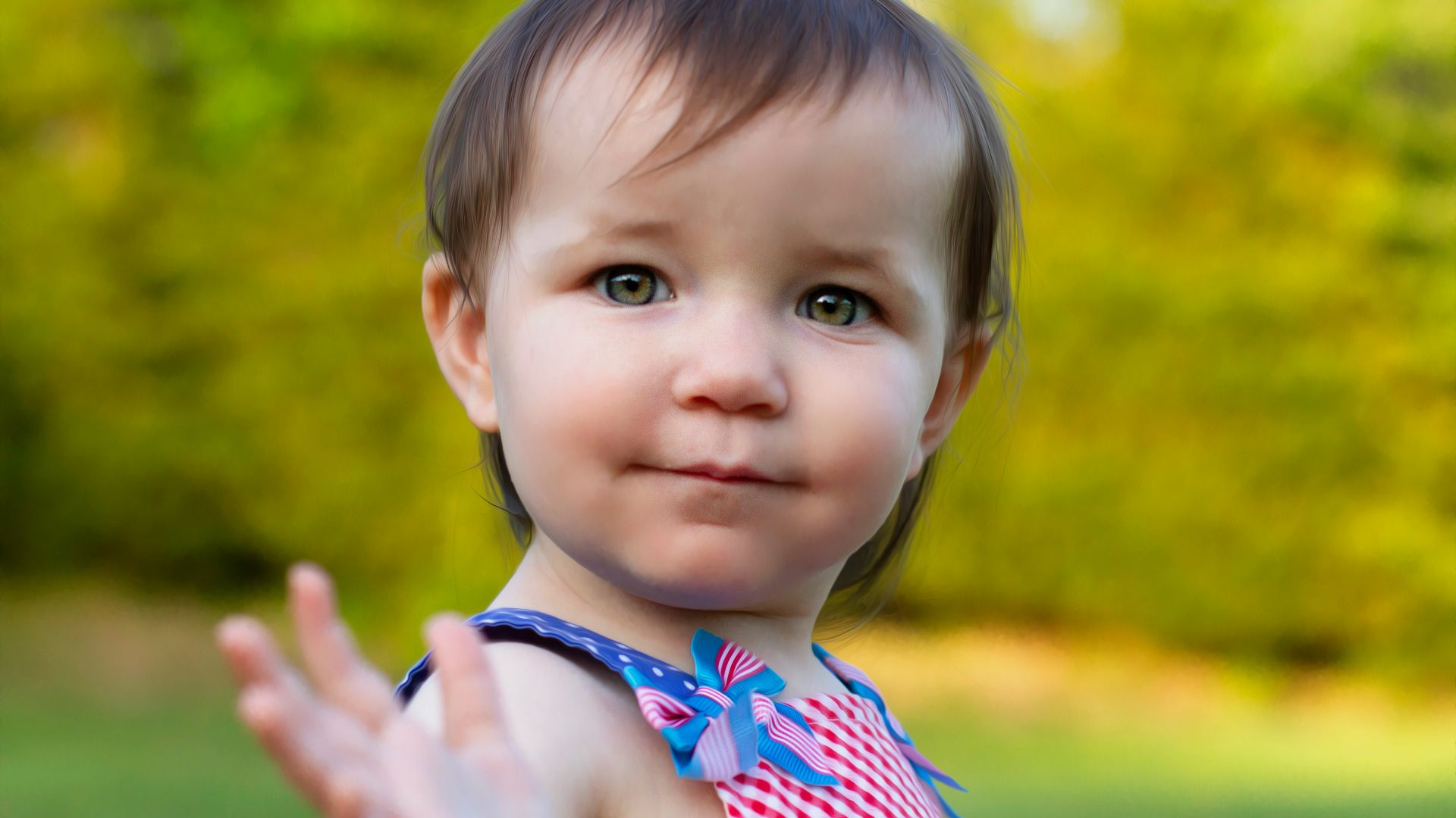 a little girl in a red and white dress holding out her hand