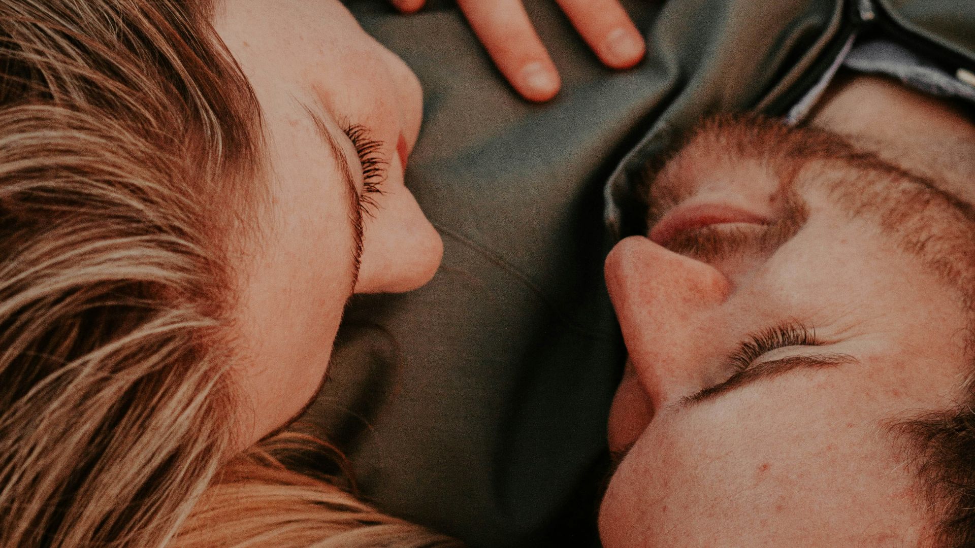 a woman stares into a man's eyes lovingly