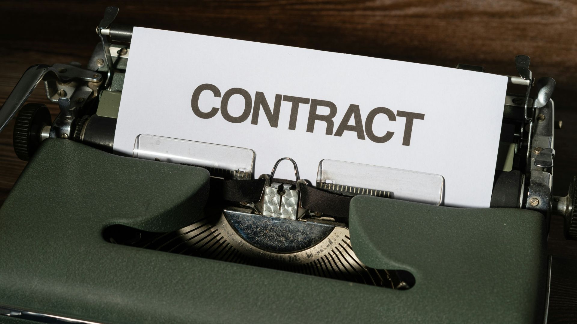 a close up of a typewriter with a sign that reads contact