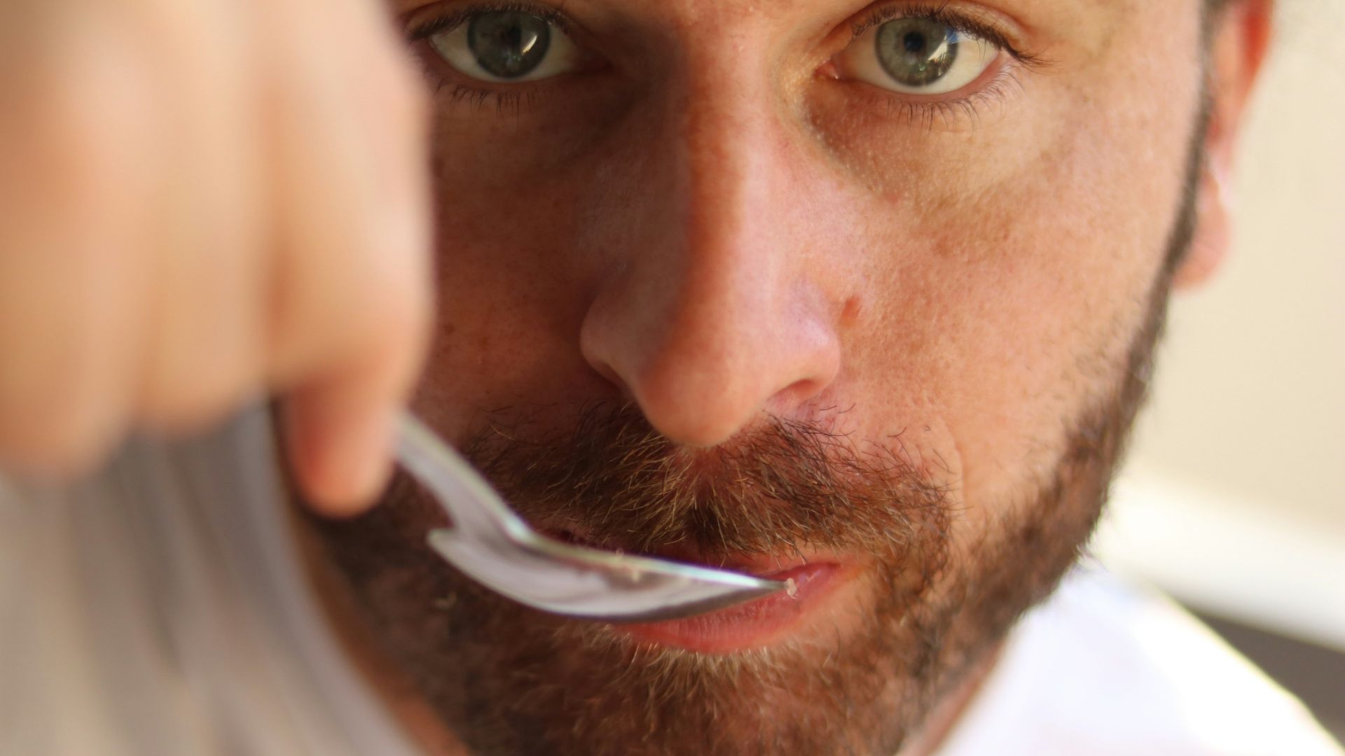 a man is brushing his teeth with a toothbrush