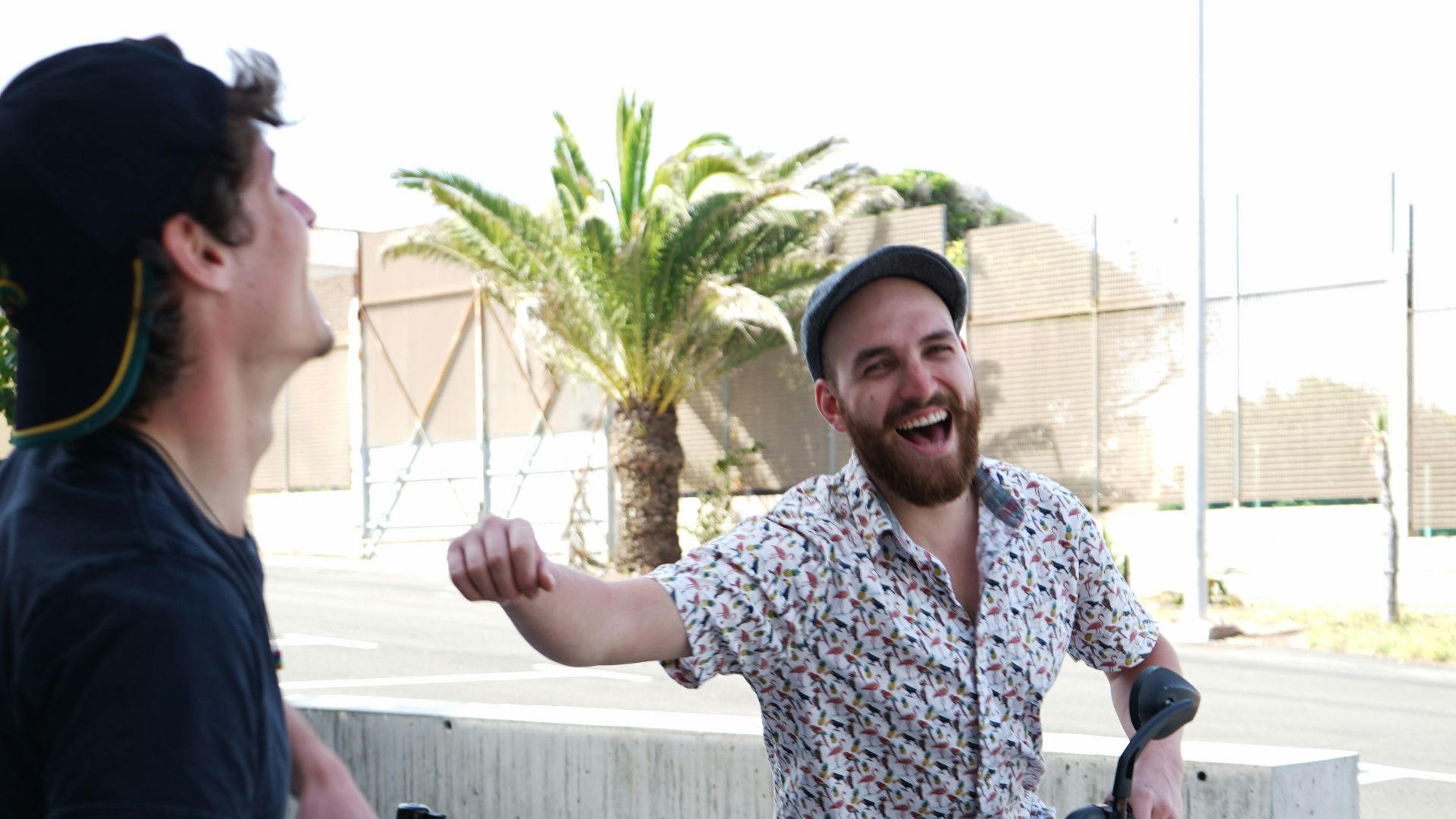 man in blue crew neck t-shirt standing beside woman in white and blue floral shirt