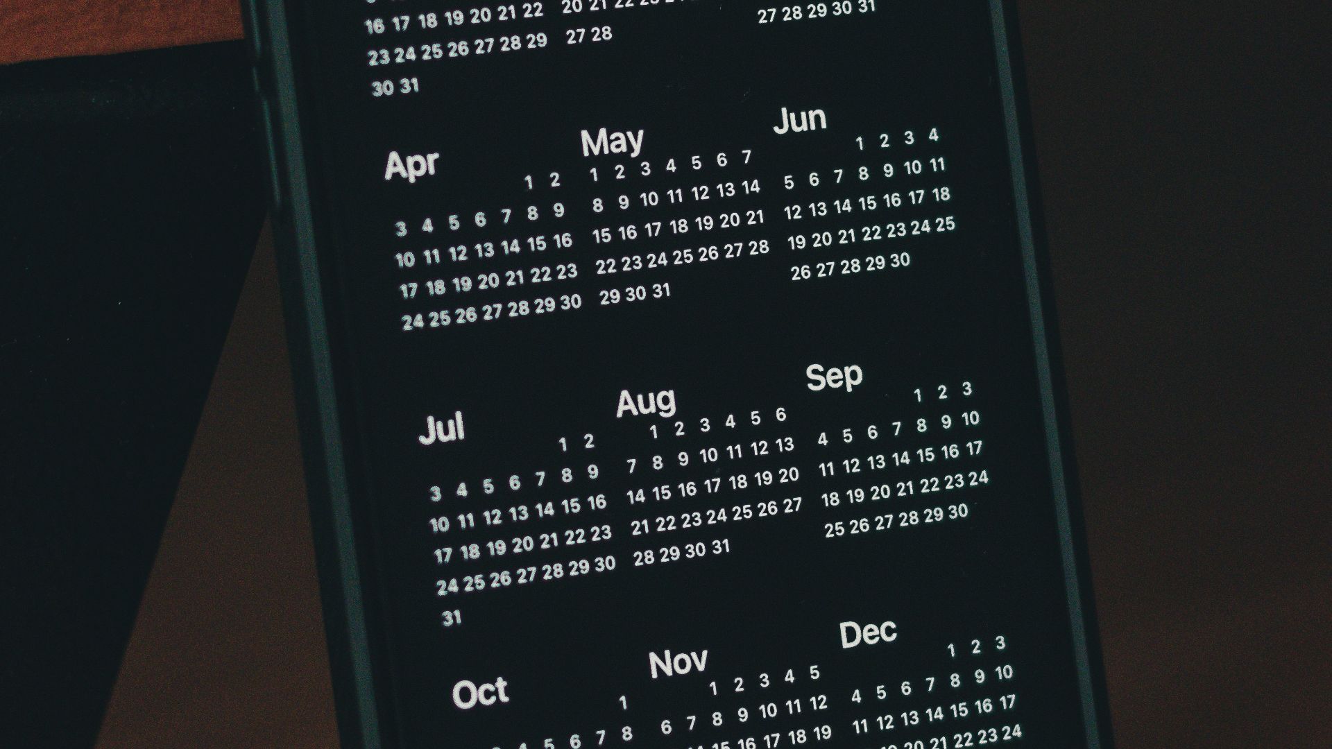a cell phone with a calendar on the screen