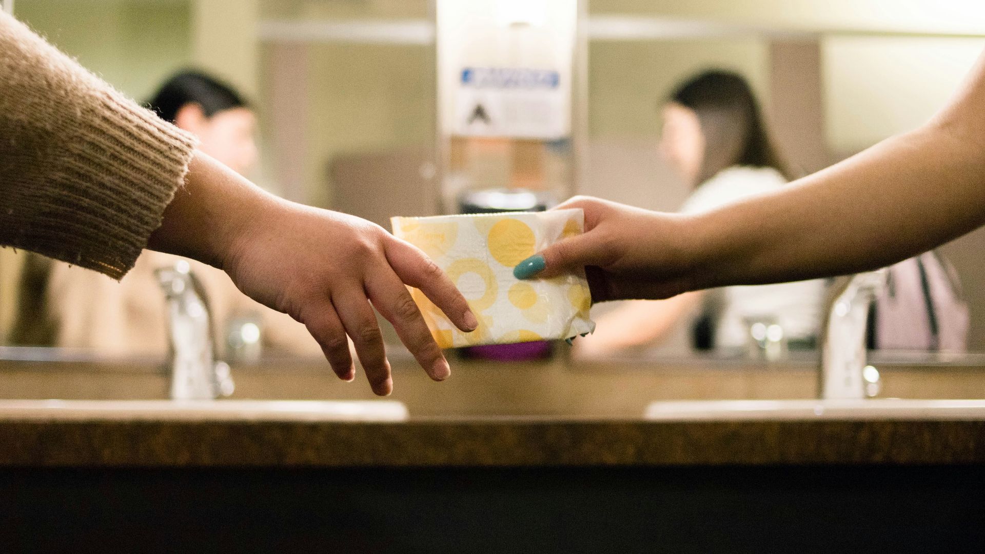person holding white and blue ceramic mug