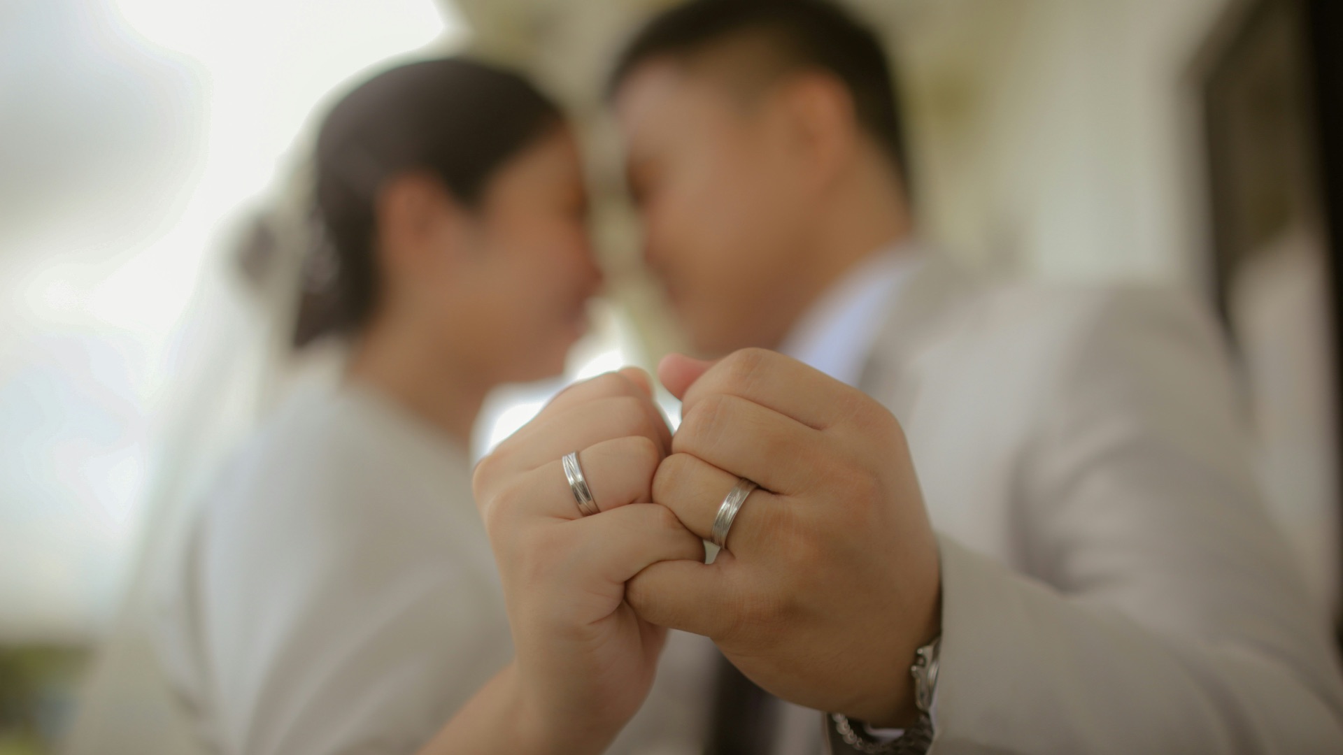 a man and a woman holding hands in front of a mirror