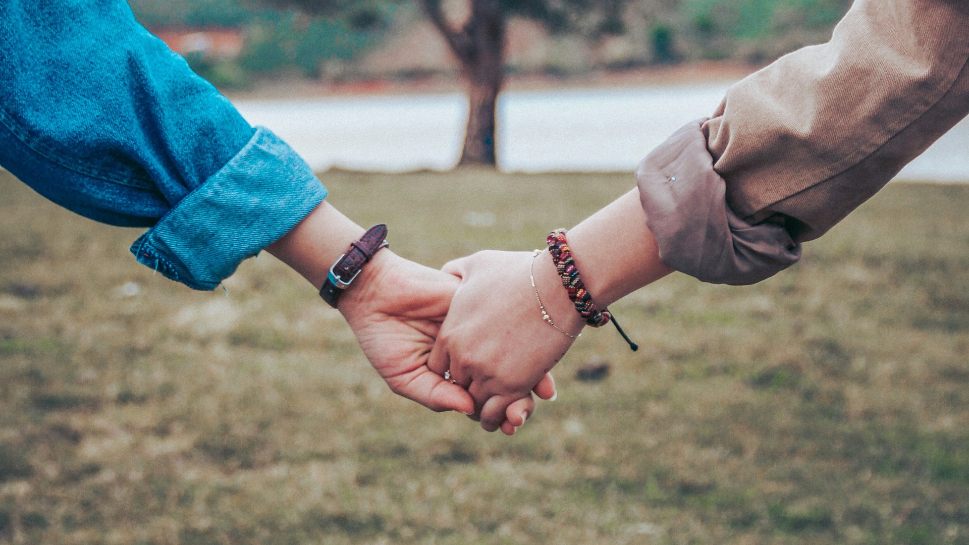 two persons holding hands