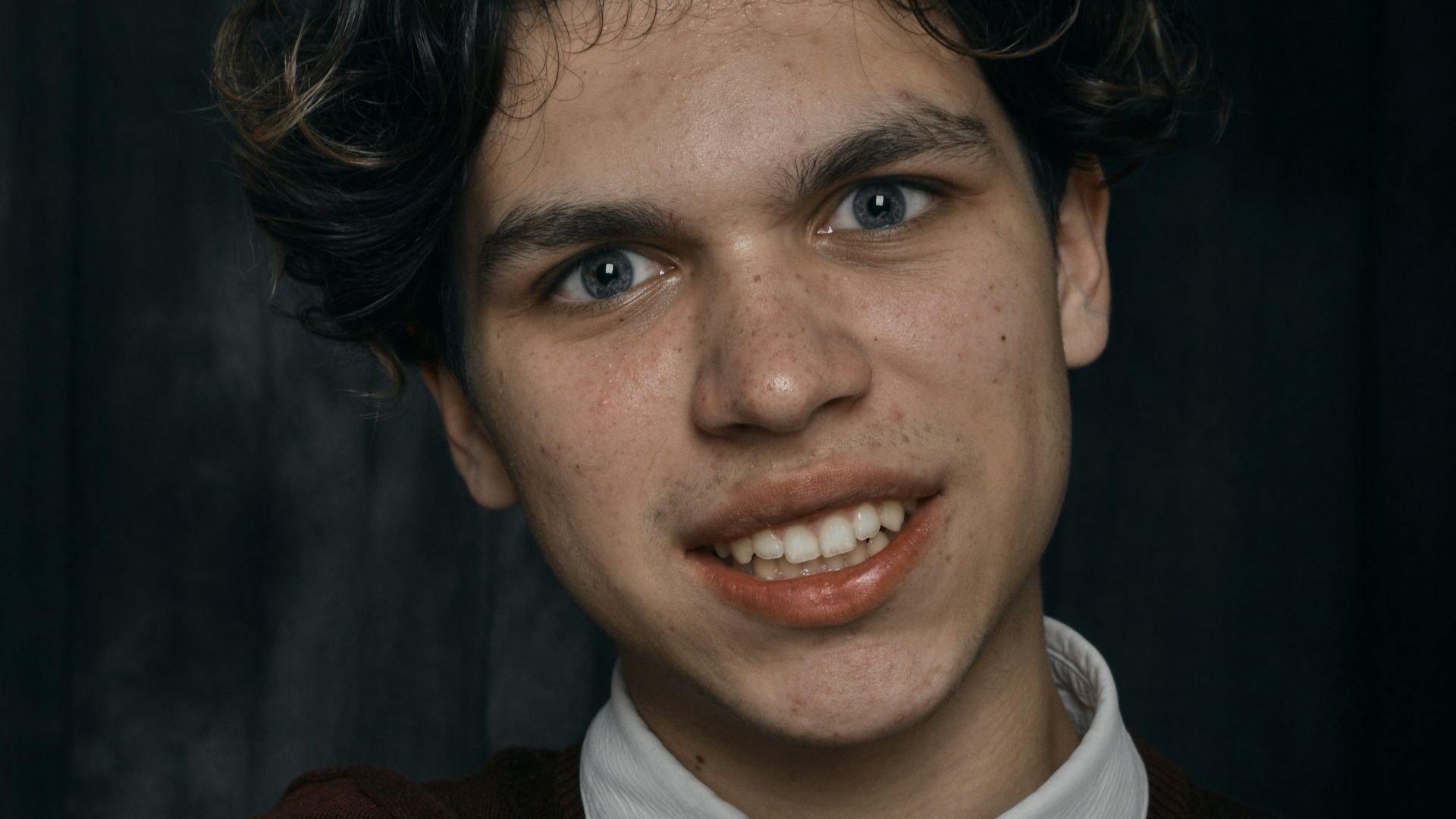 a young man making a hand gesture with his fingers