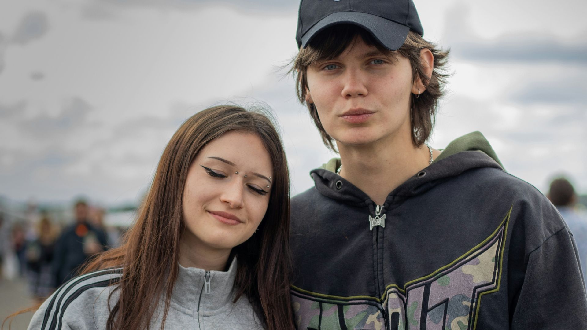 Young couple holding drinks outdoors