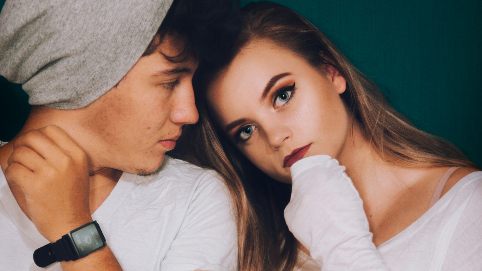 man standing beside woman while staring