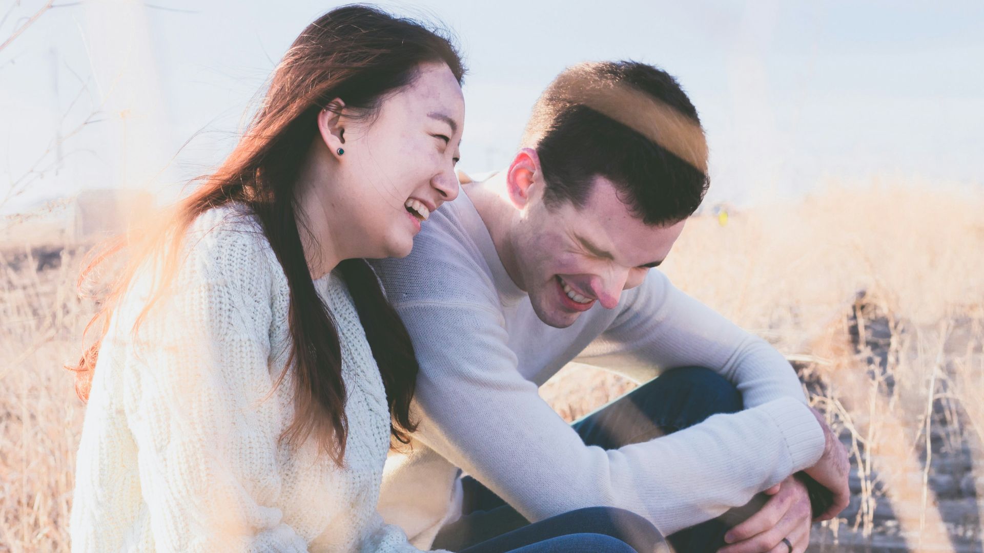 photo of man and woman laughing during daytime
