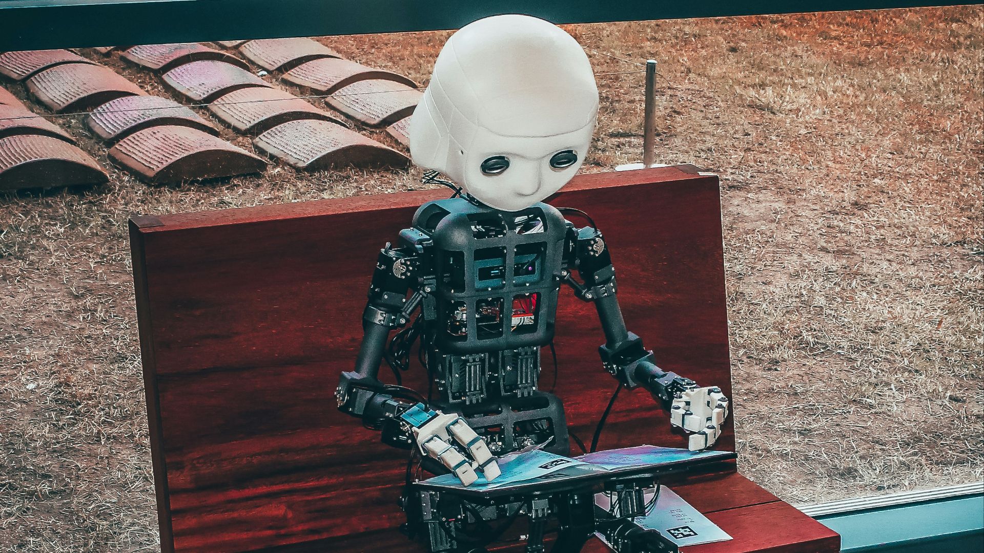 black and white robot toy on red wooden table