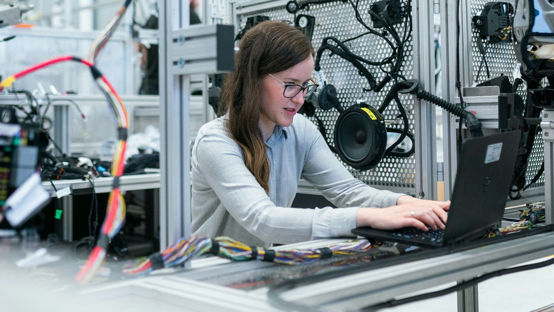 woman in white long sleeve shirt using black laptop computer