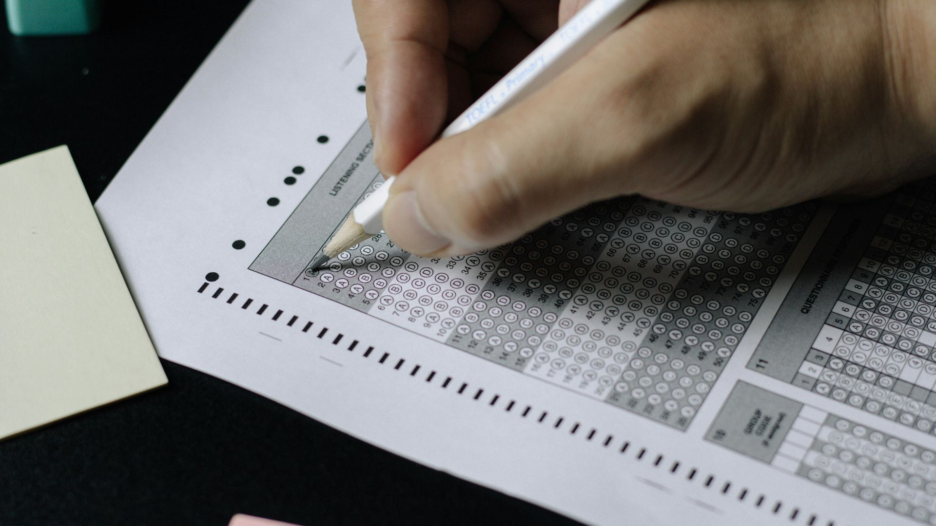 person writing on white paper