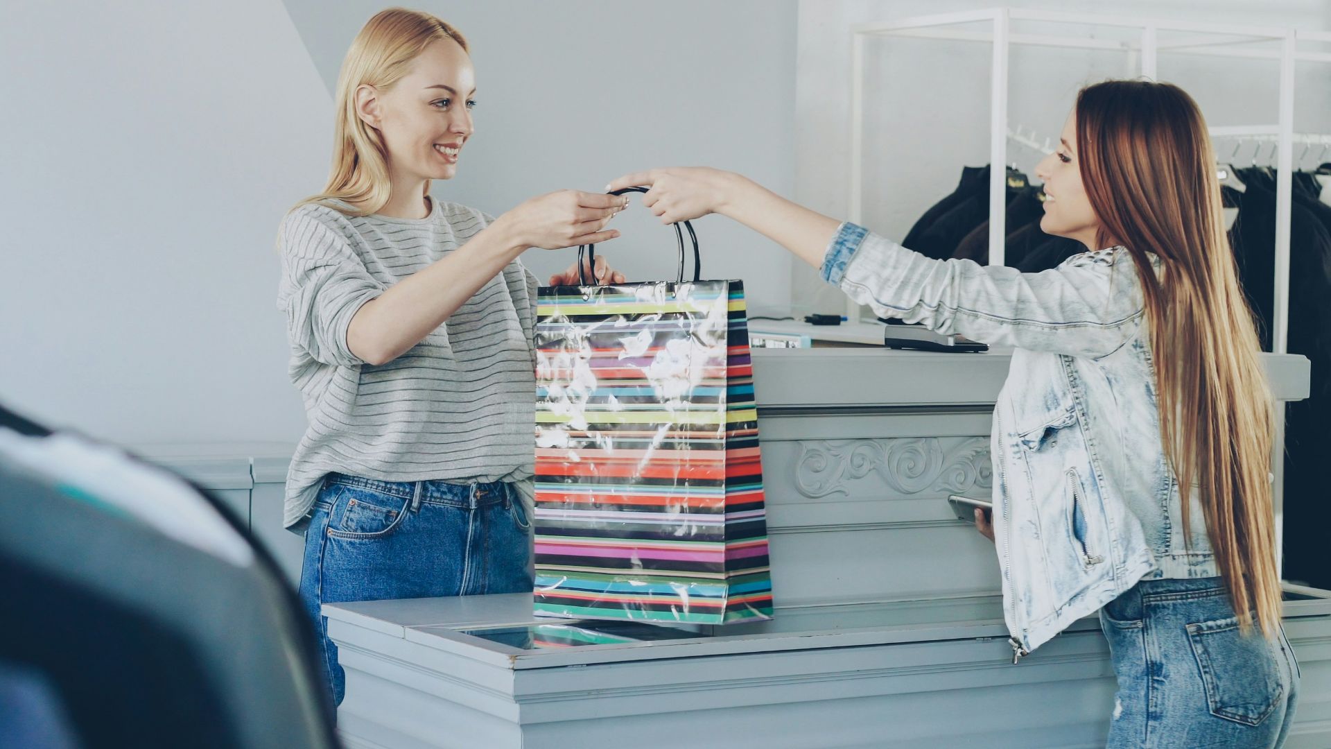 A customer receives a shopping bag at the store.
