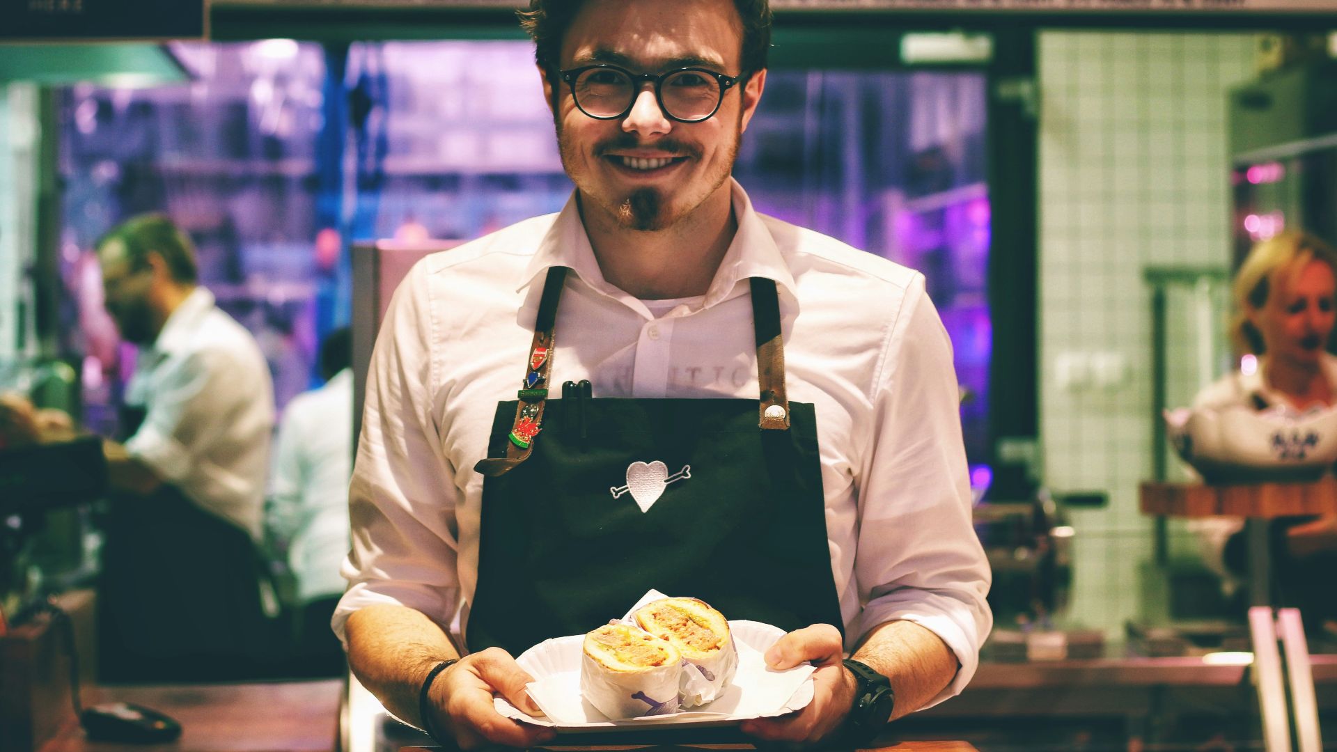 man holding fish dish on plate
