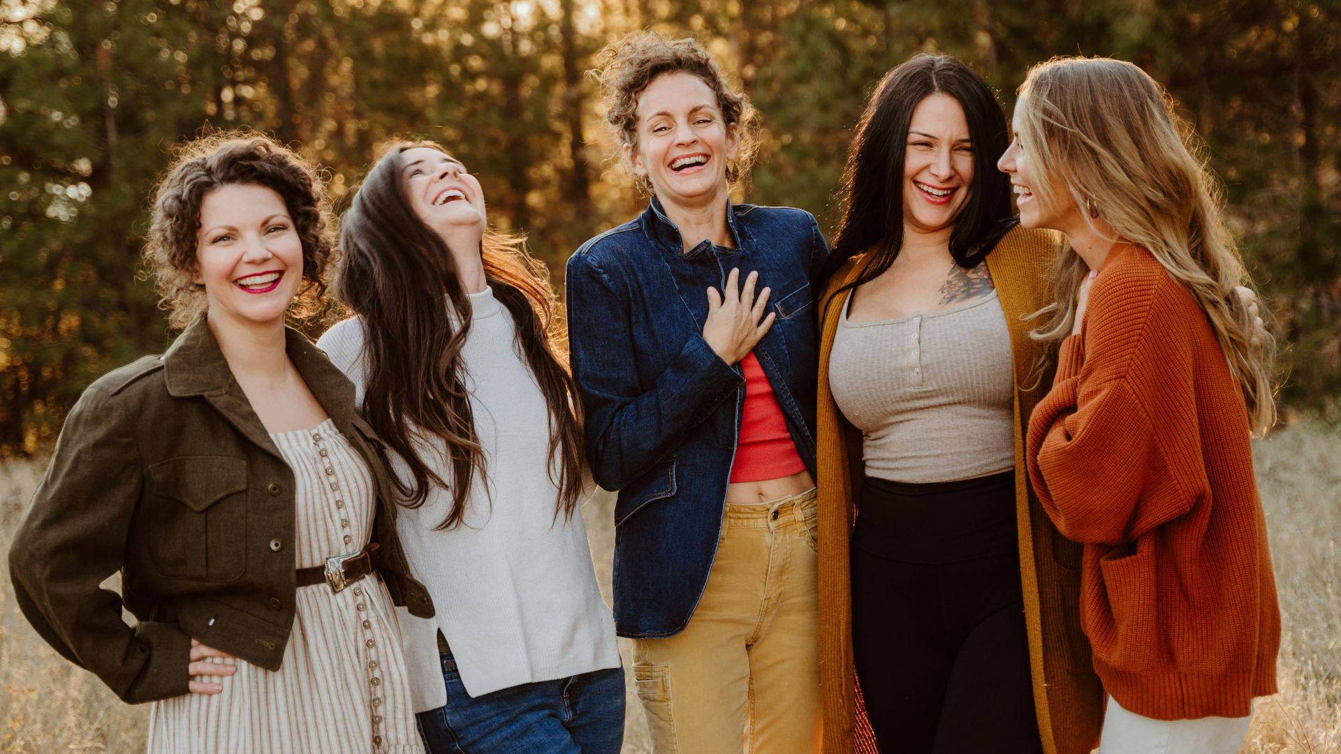 A group of women standing next to each other in a field