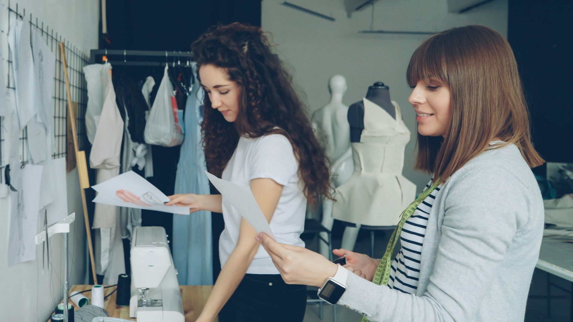 Two fashion designers collaborate in a workshop.
