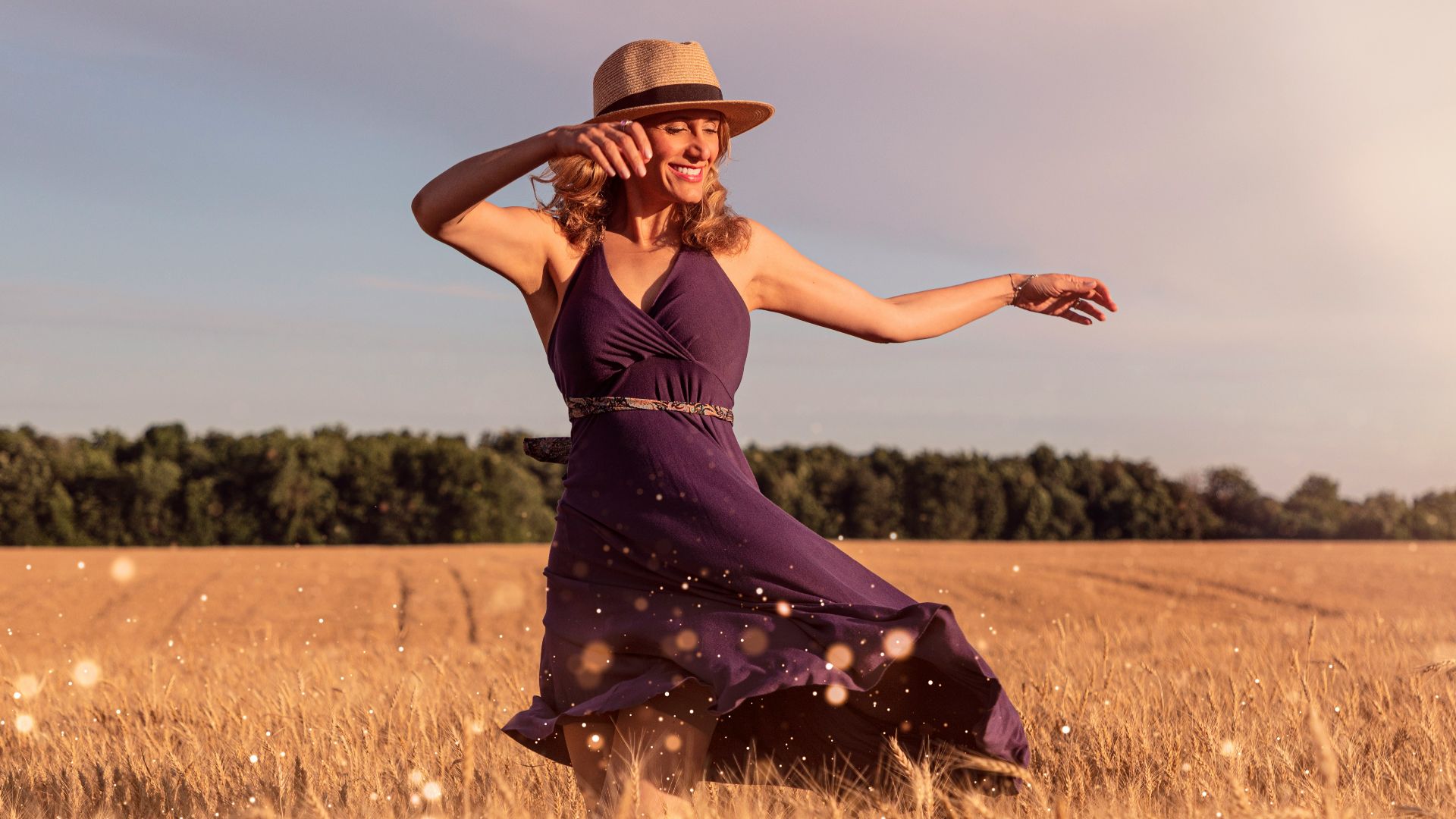 woman in brown sun hat standing on wheat field during daytime