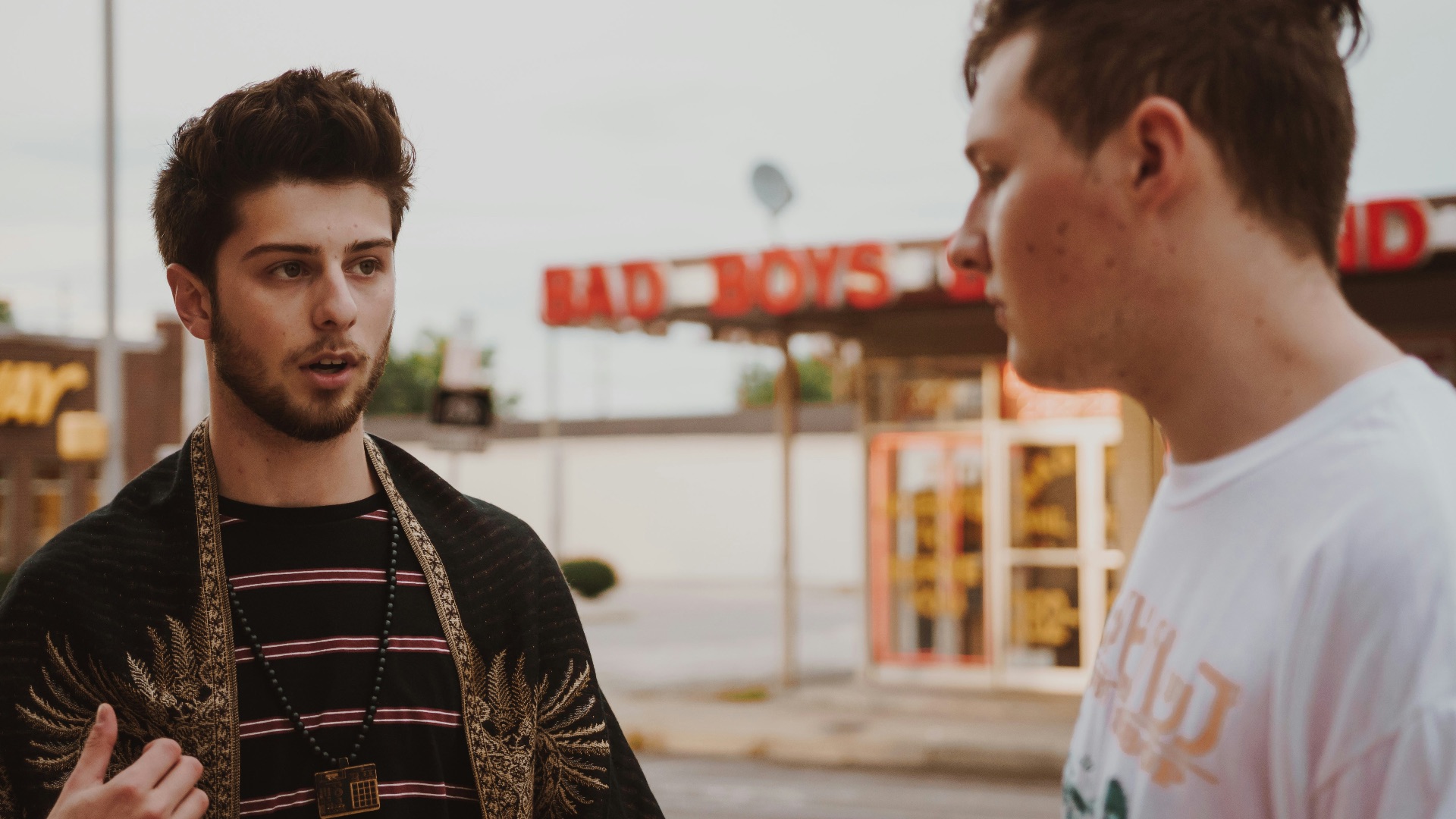 man talking to another man