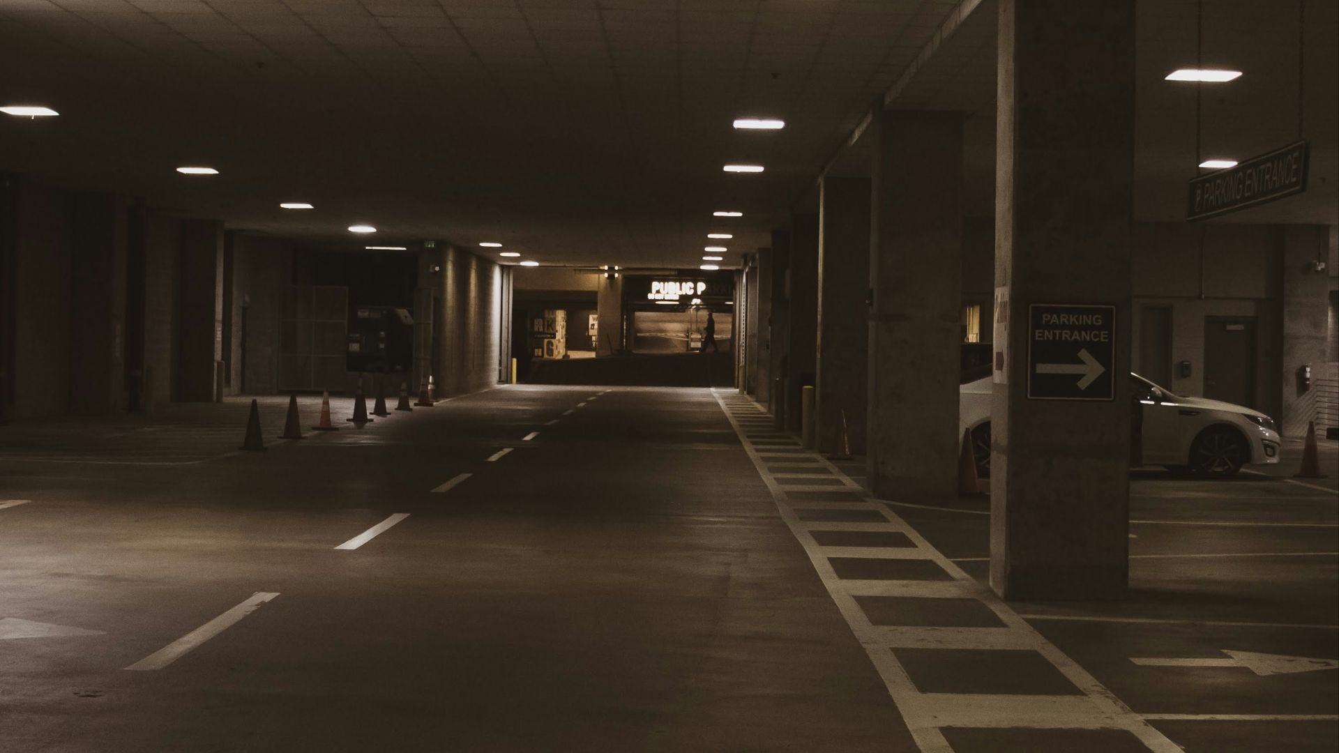 an empty parking garage at night with lights on
