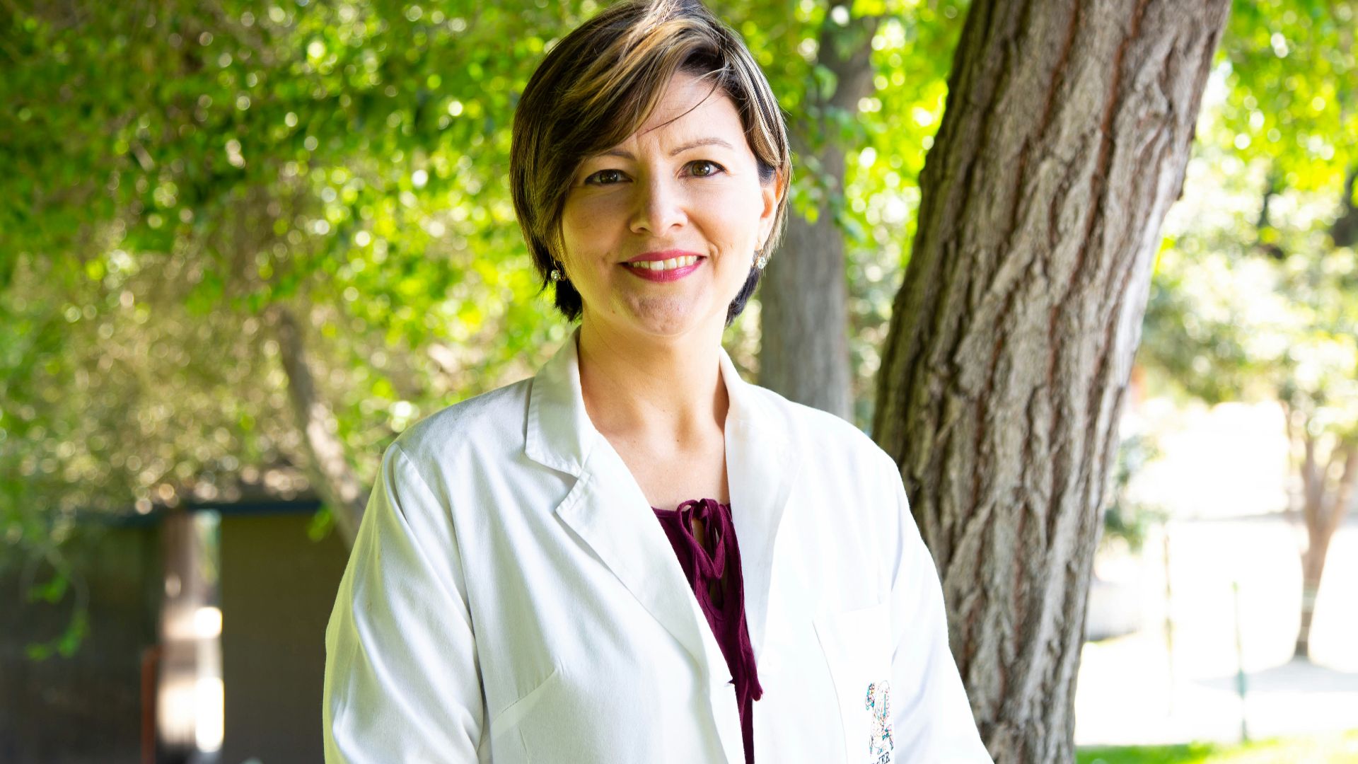 woman standing under tree