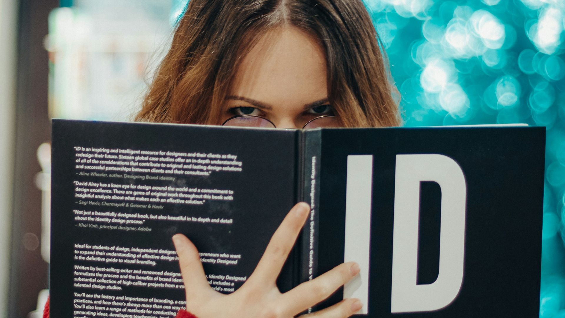 woman holding opened ID book