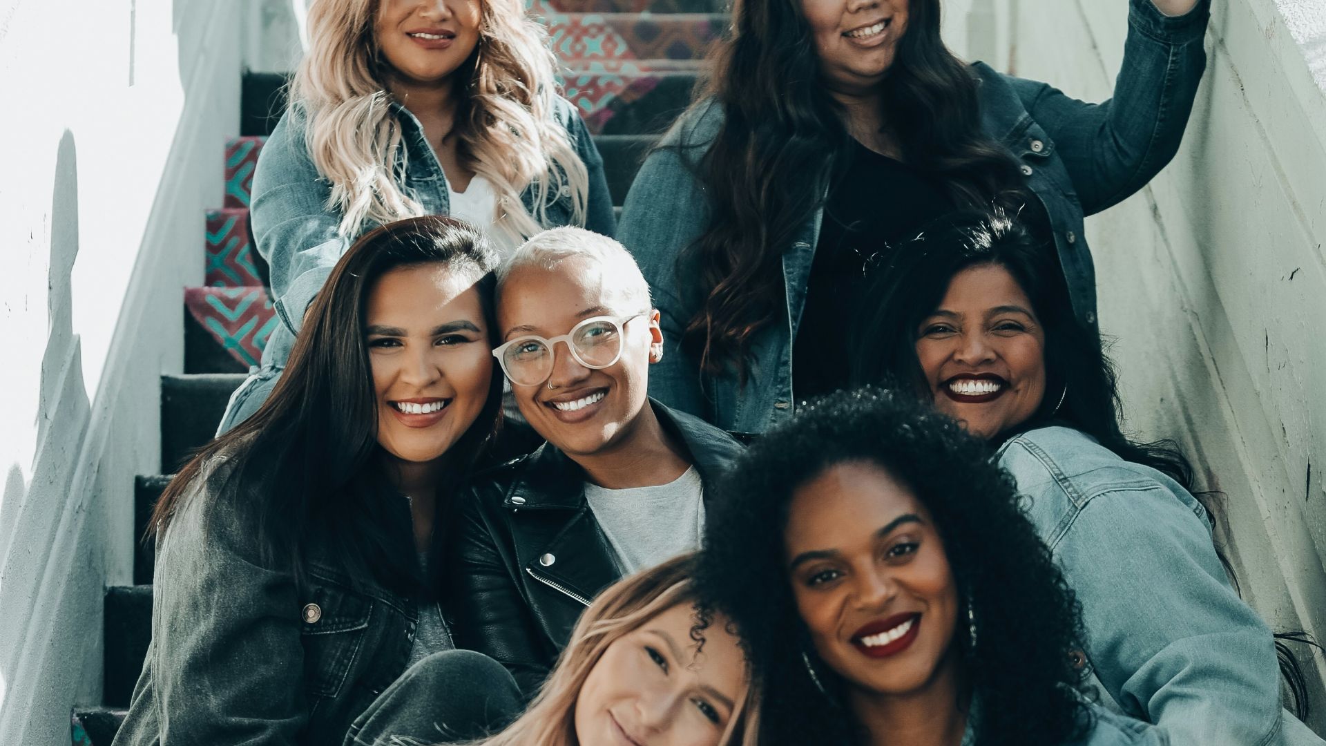 2 women sitting on black chair