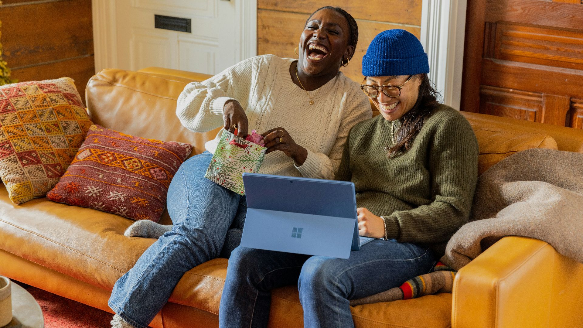 a person sitting on a couch with a laptop
