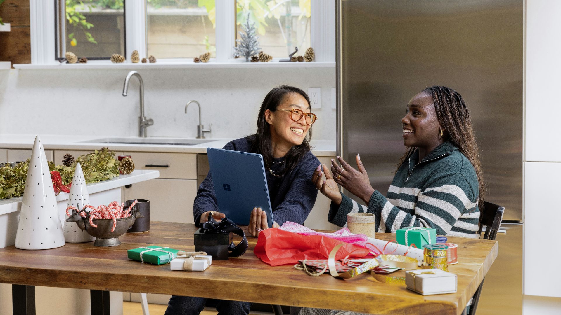 a woman sitting at a table in front of a window